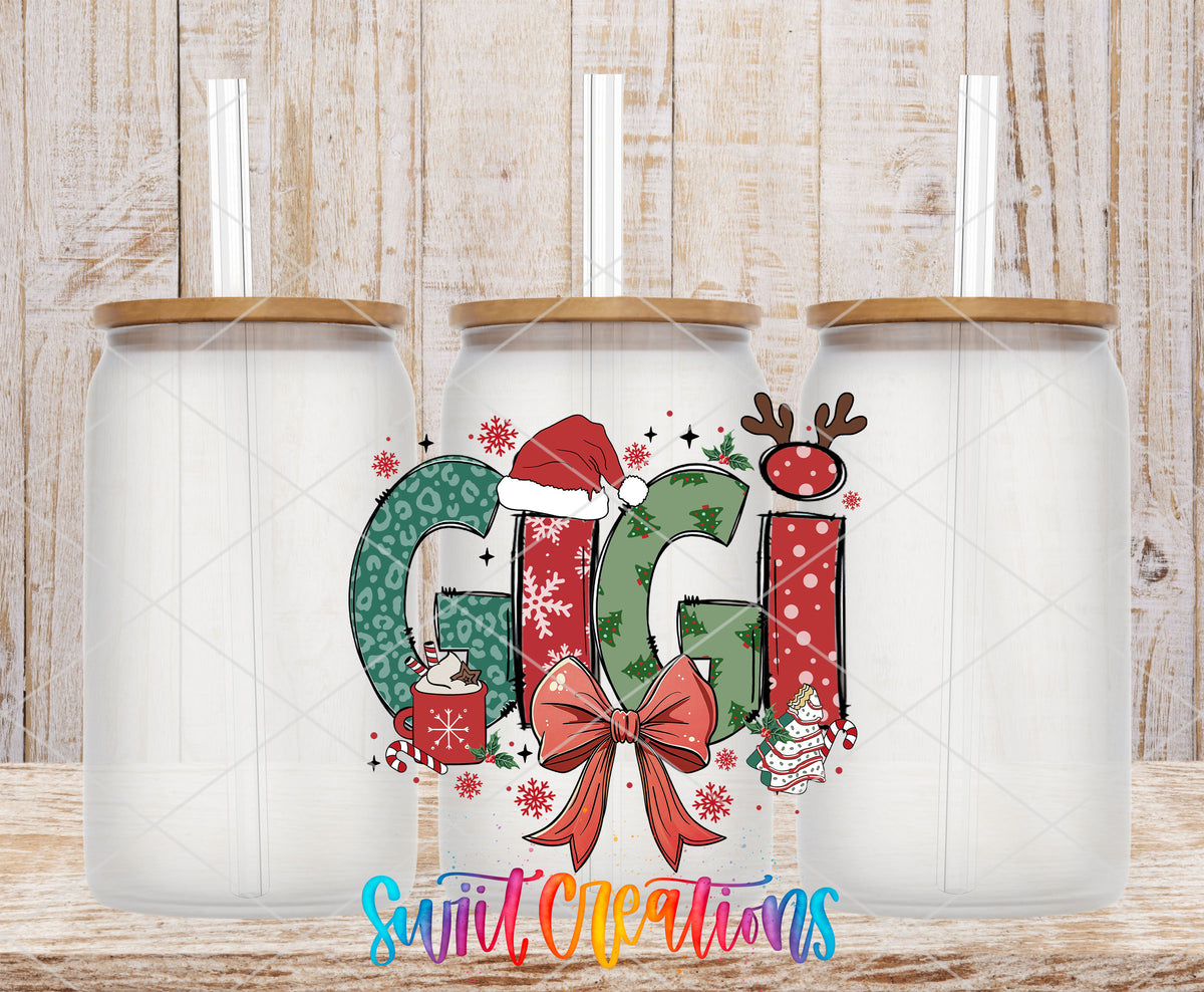 Gigi Christmas UV DTF transfer on three frosted glass cans on a wood background