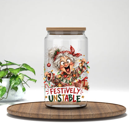 Festively Unstable grandma UV DTF transfer on a clear glass can on a wood tray with greenery