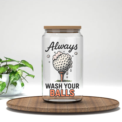 Always Wash Your Balls UV DTF transfer on a clear glass can beside a green plant