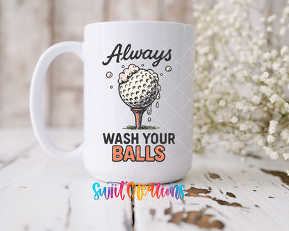 Always Wash Your Balls UV DTF transfer on a 15 oz white ceramic mug beside white flowers