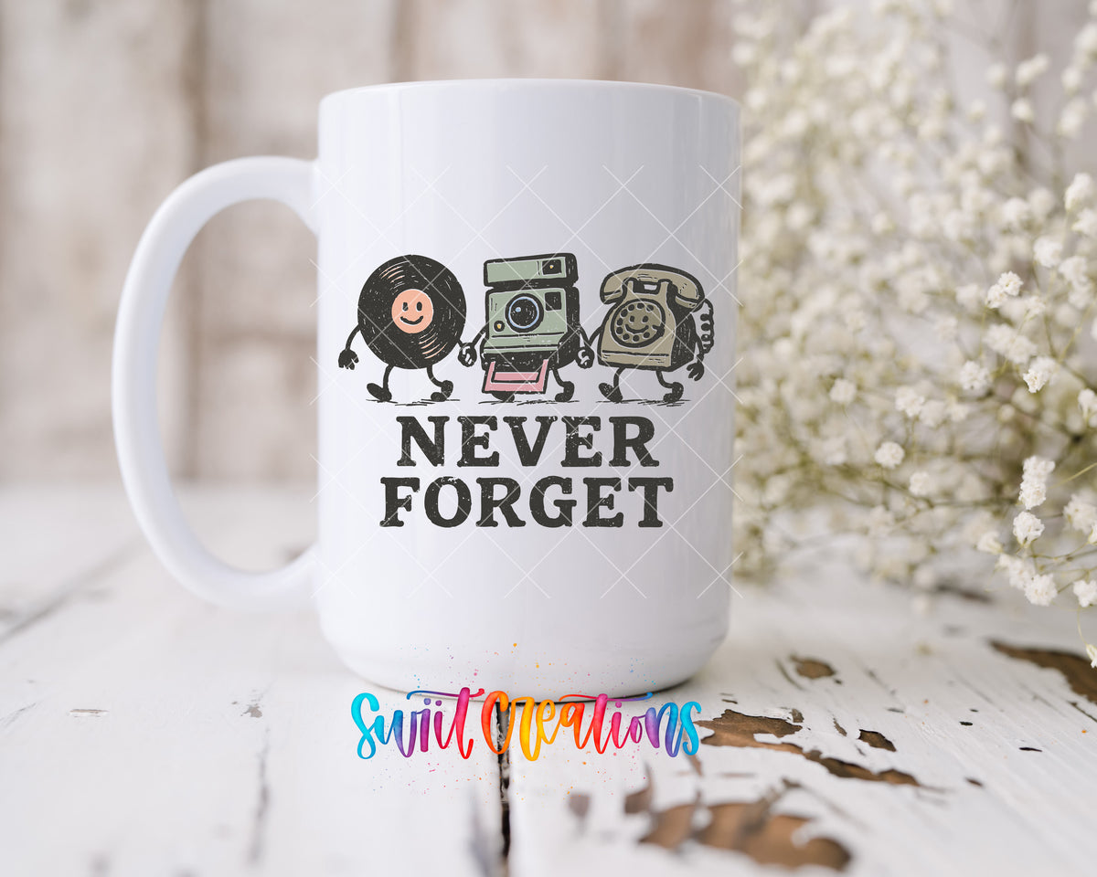 Never Forget UV DTF transfer on a 15 oz white ceramic mug beside white flowers