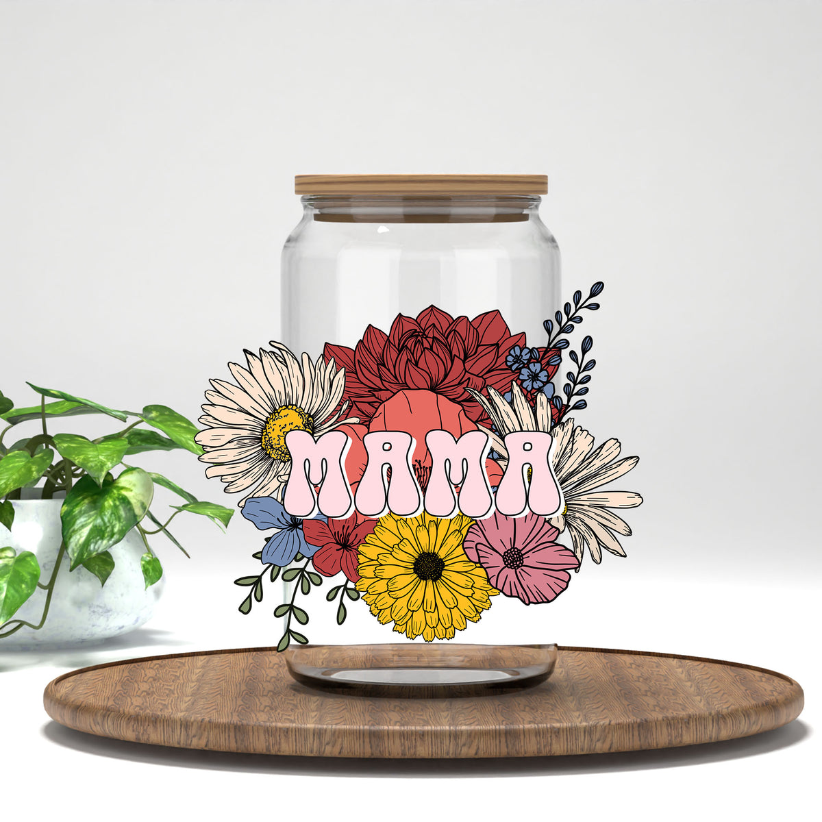 Mama pink letters and wildflowers UV DTF transfer on a clear glass can