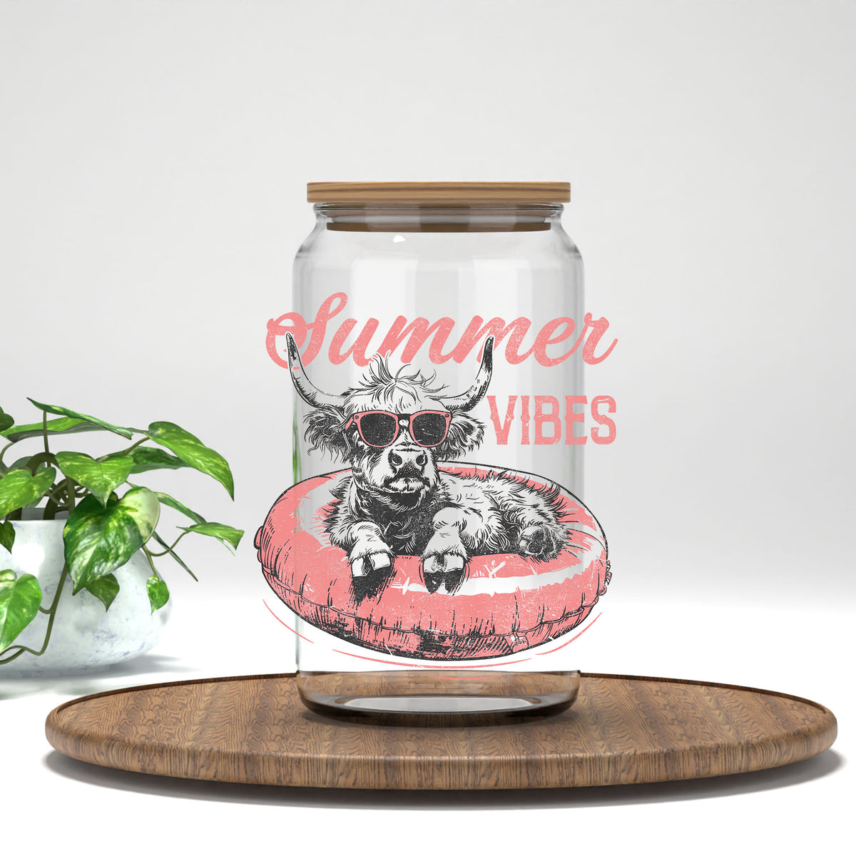 Summer Vibes highland cow on a pink float UV DTF transfer on a clear glass can
