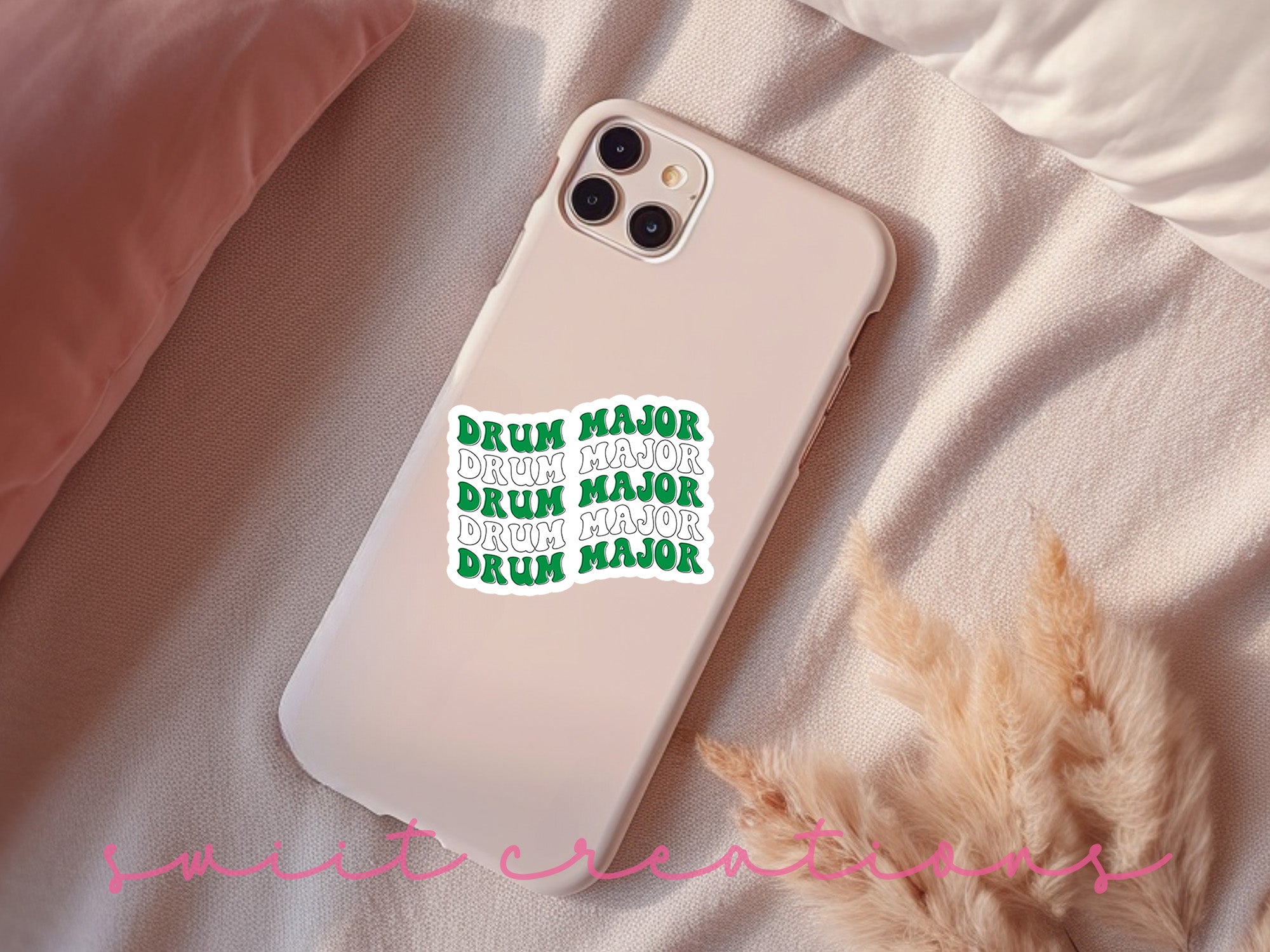 a white phone case with a green sticker on it