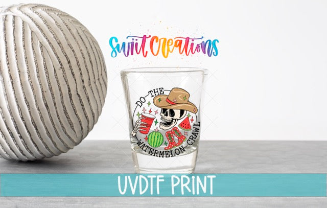 a ball of yarn next to a shot glass