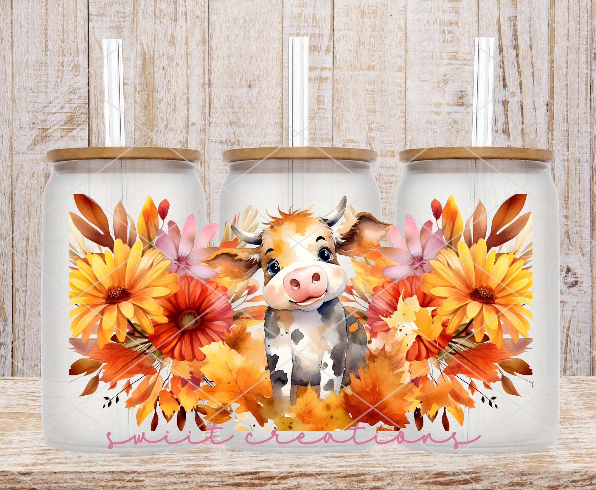 two coffee mugs with a picture of a cow and flowers on them