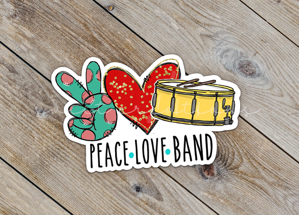 Close-up of the Peace Love Band sticker on rustic wood