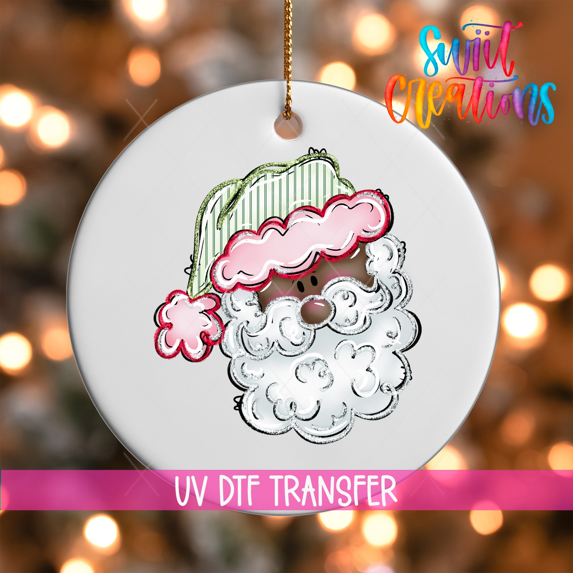 A white ornament with a Santa Claus face design, featuring a pink cloud and a green striped hat, is hanging against a background of colorful lights.