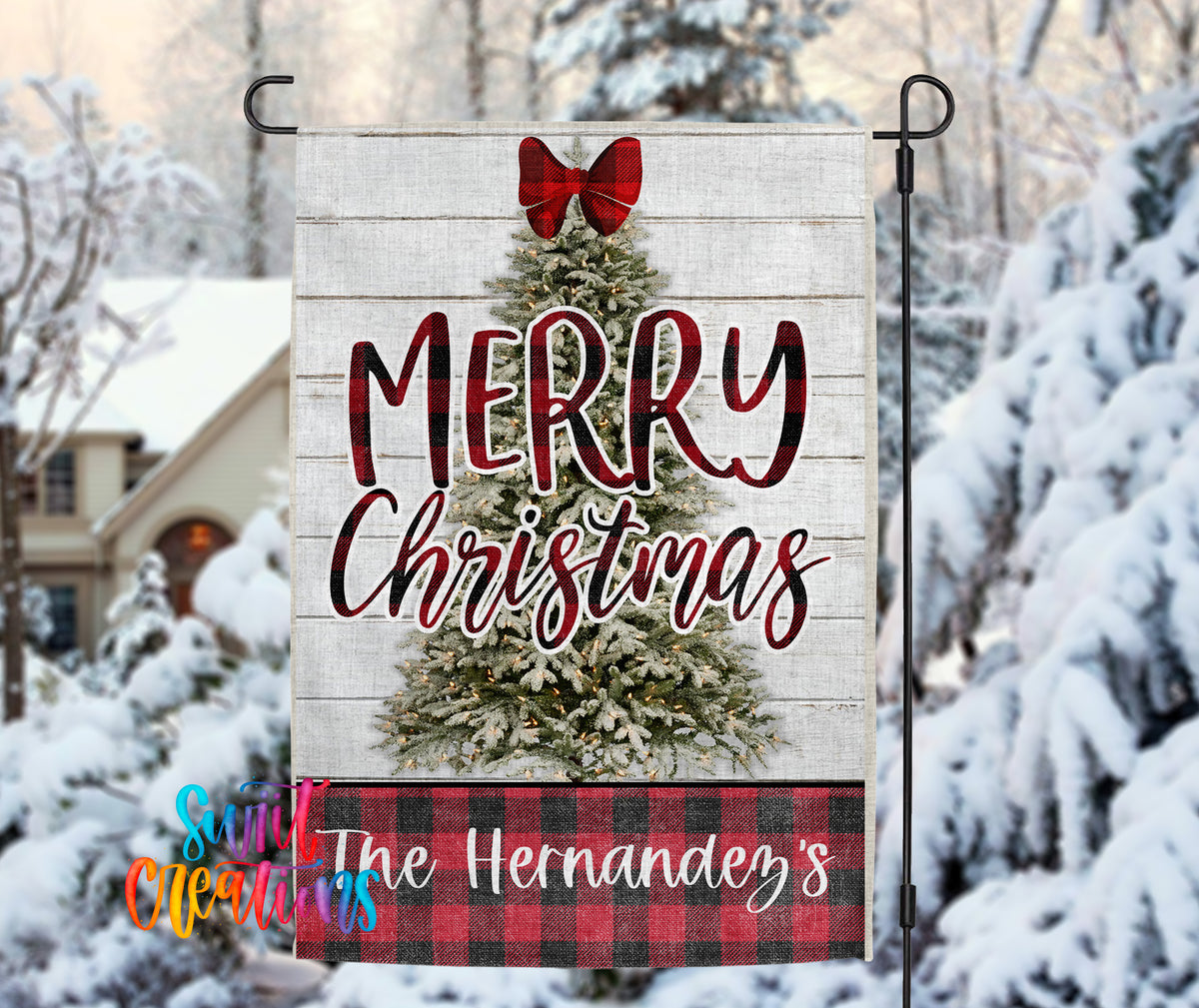 A wooden Christmas tree with a red bow, surrounded by snow-covered trees, with a banner that says "MERRY CHRISTMAS" and "The Hernández's" below it.