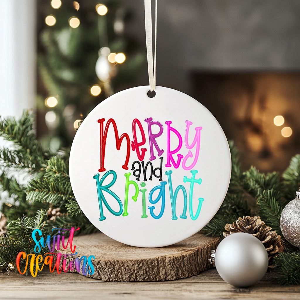 A white ceramic ornament with the text "Merry and Bright" in colorful letters is displayed on a wooden surface, surrounded by Christmas decorations such as pine cones and ornaments.