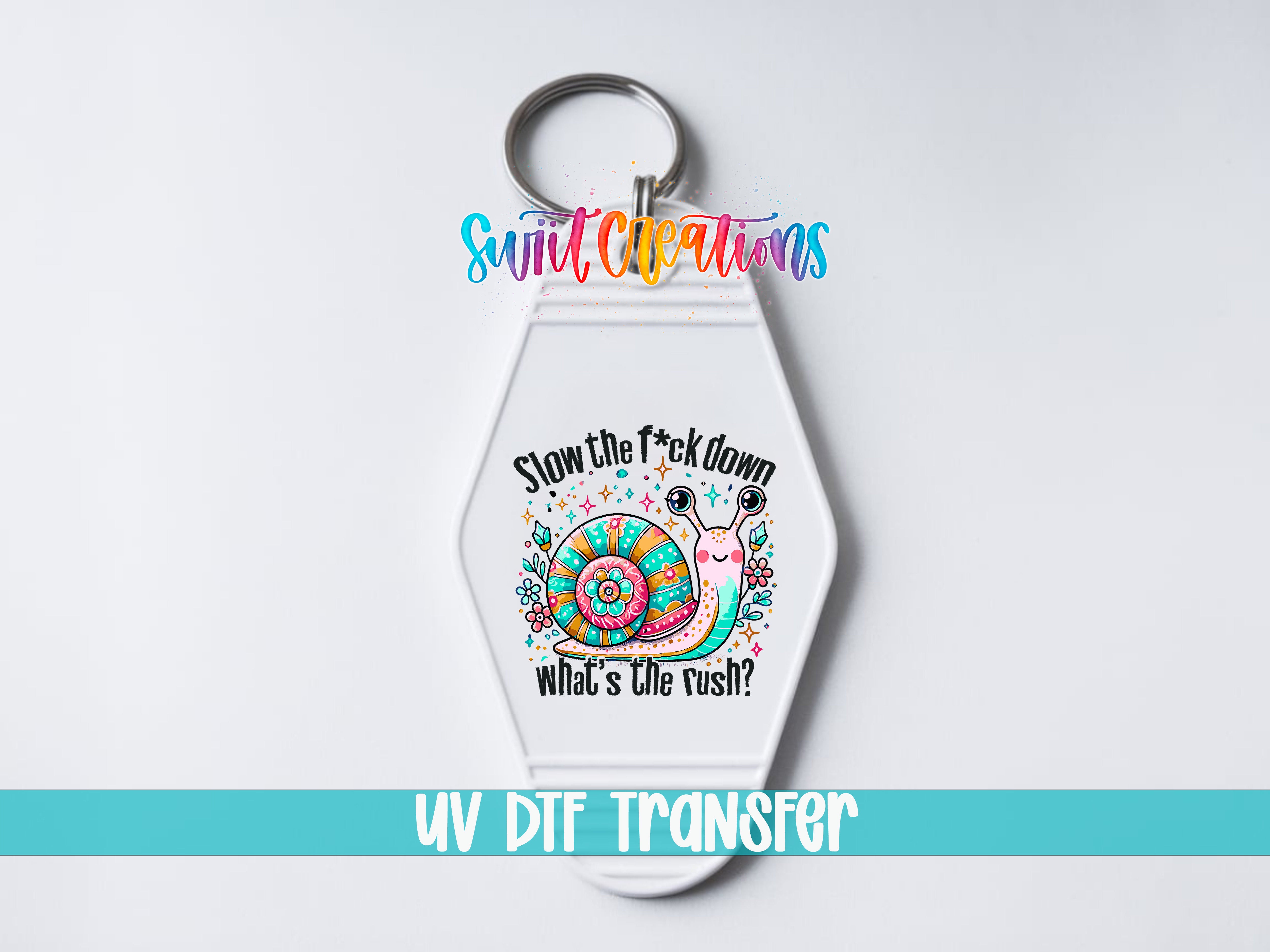 A keychain with a colorful design featuring a snail and the text "Slow the fuck down what's the rush?"