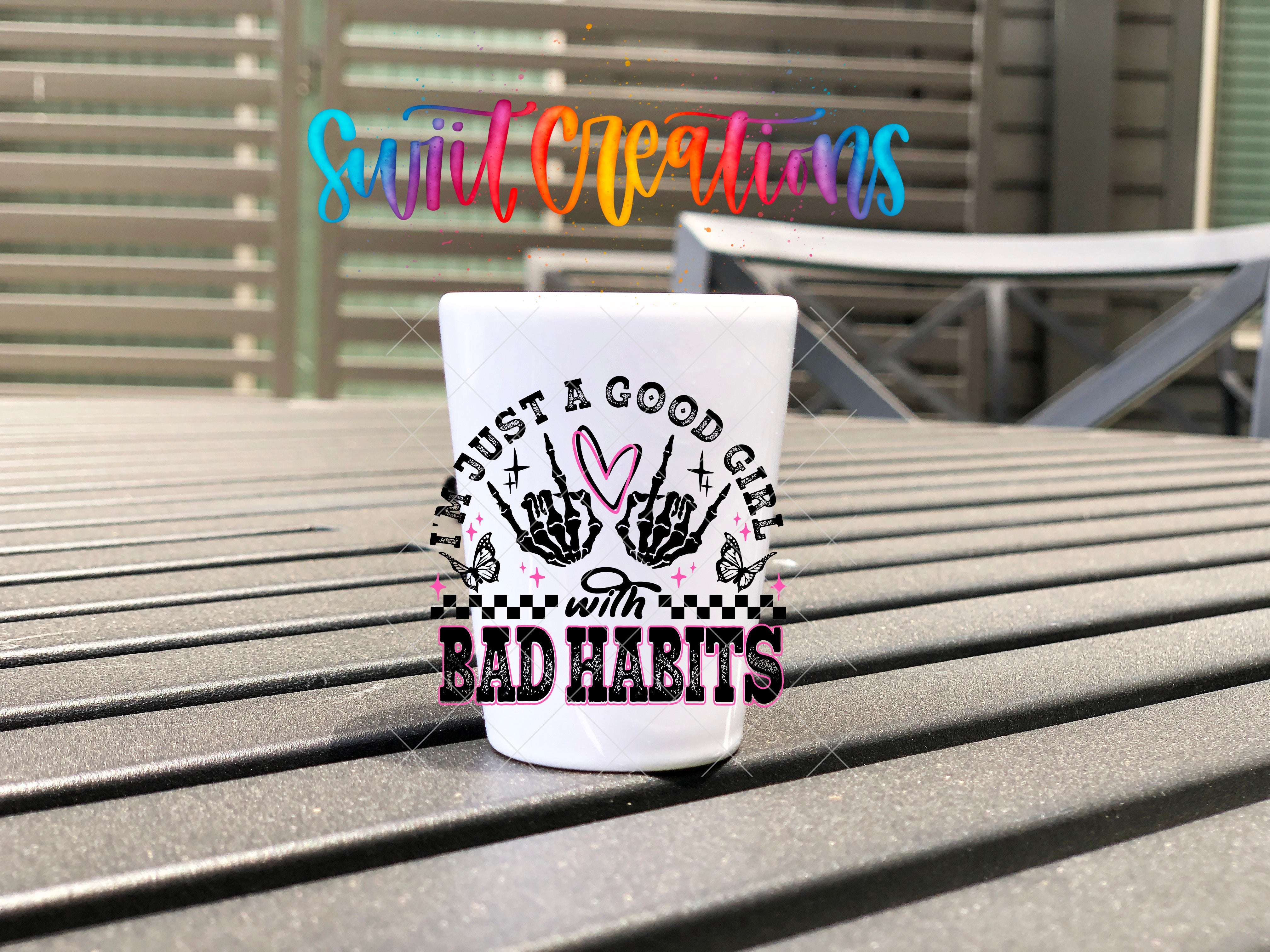 a white cup sitting on top of a wooden table