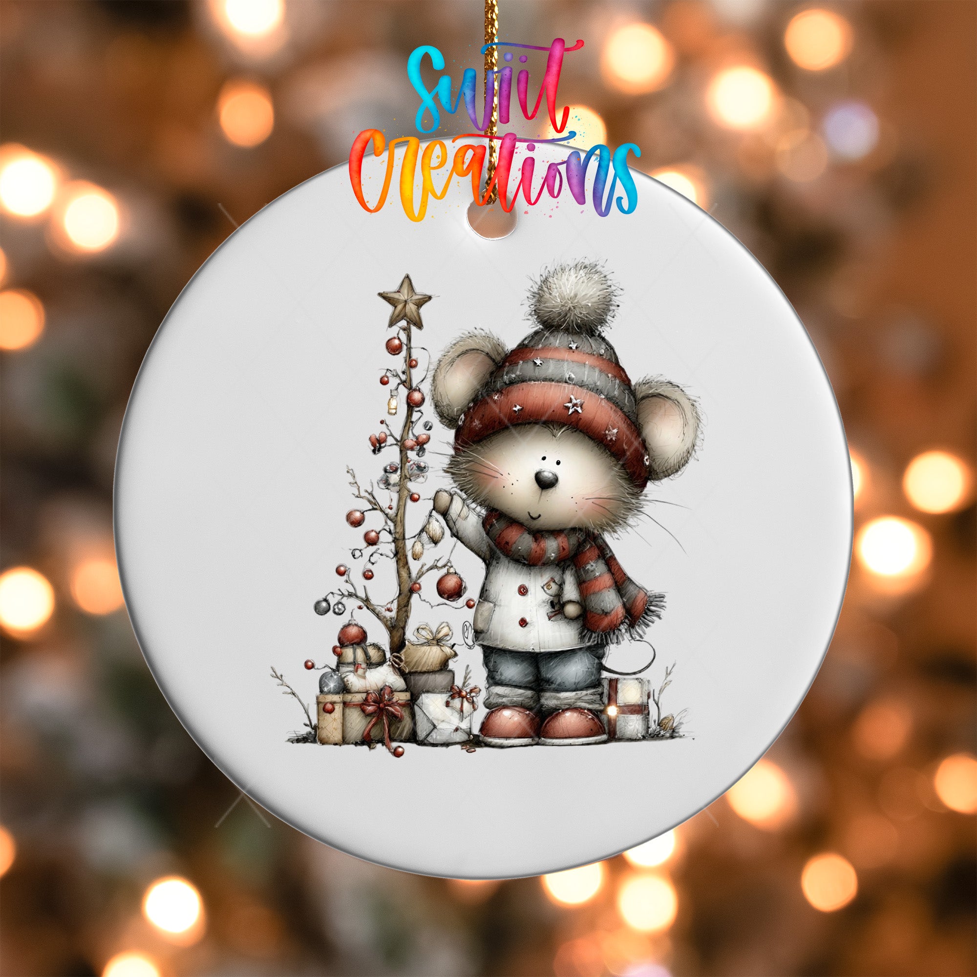 A white ceramic ornament featuring a cartoon mouse standing next to a Christmas tree, with presents and a star on the tree.