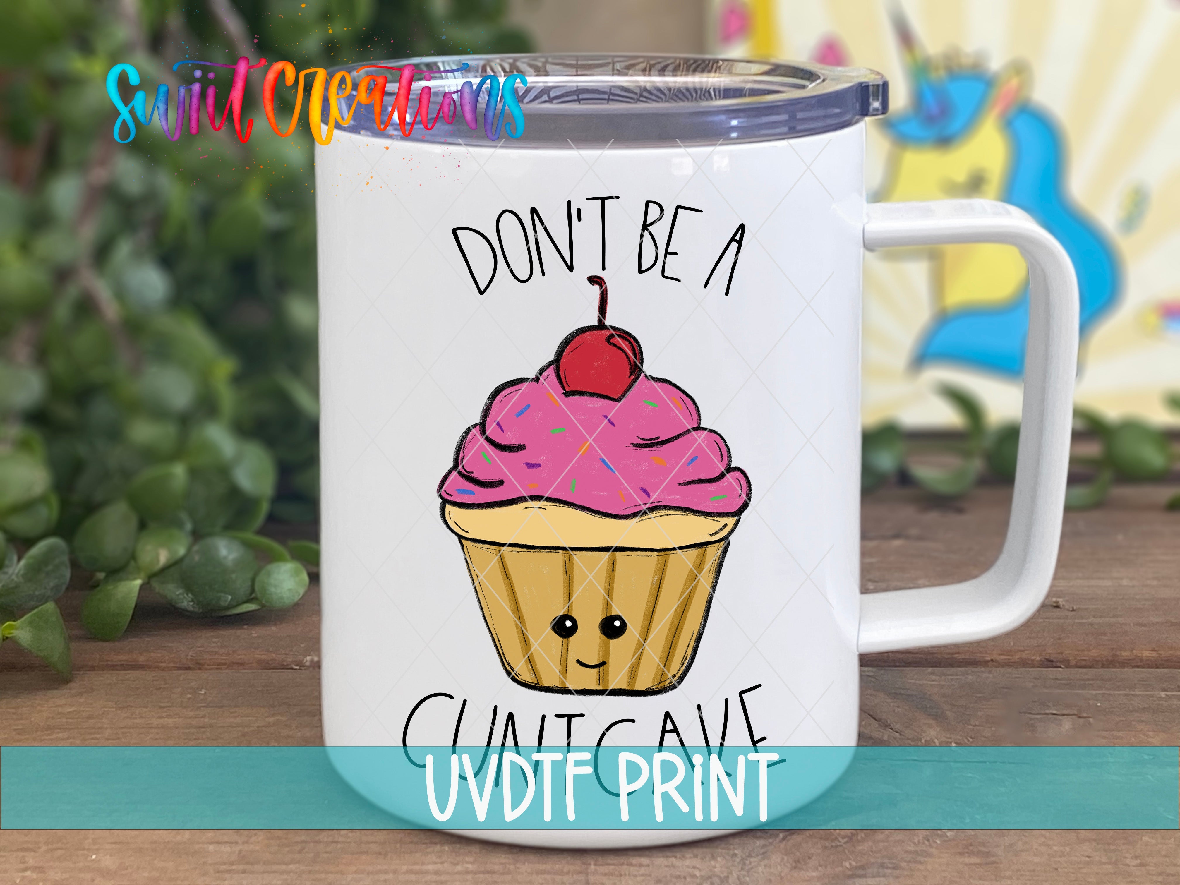 a white coffee mug with a pink frosted cupcake on it