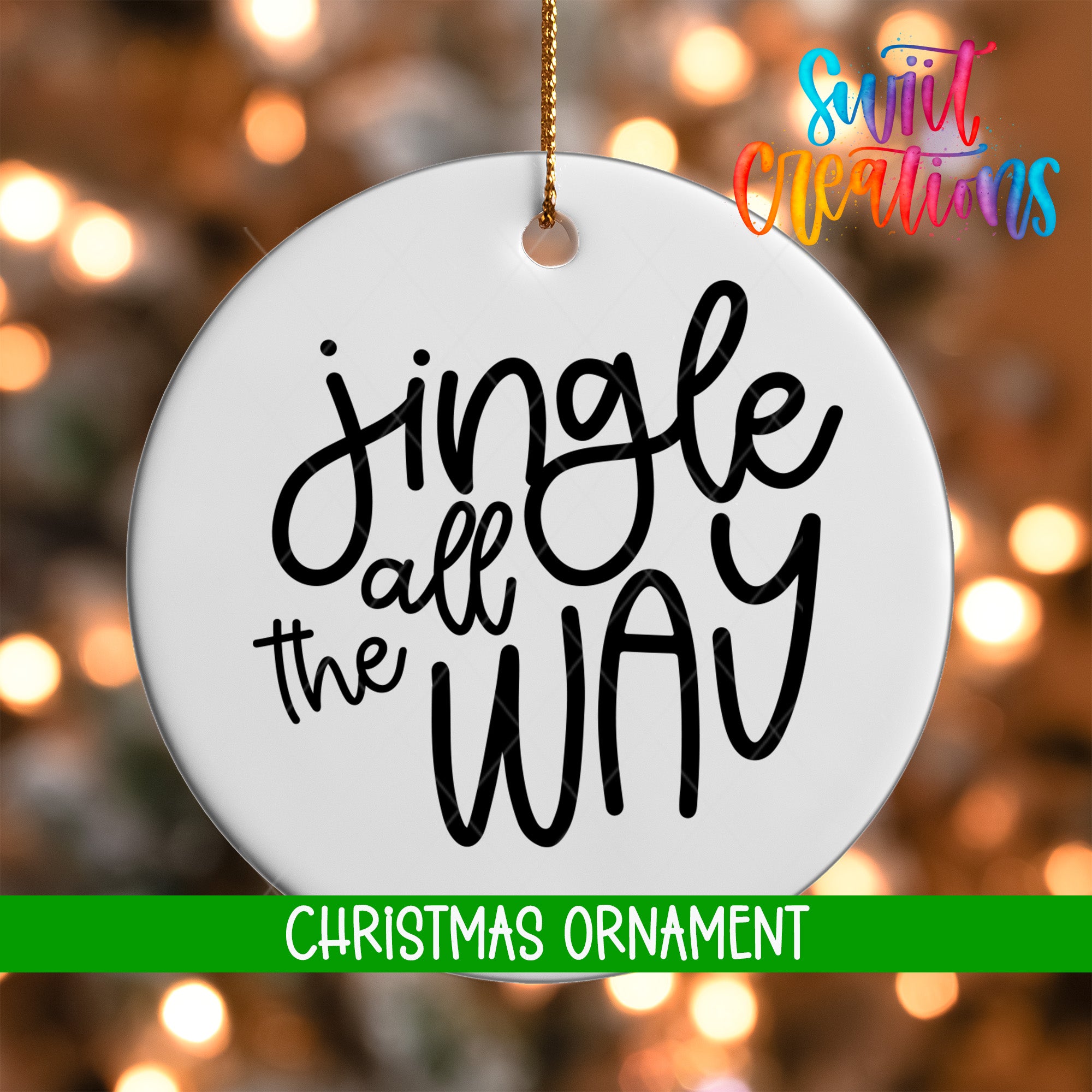 A white Christmas ornament with the text "Jingle all the way" written on it, hanging against a background of colorful lights.