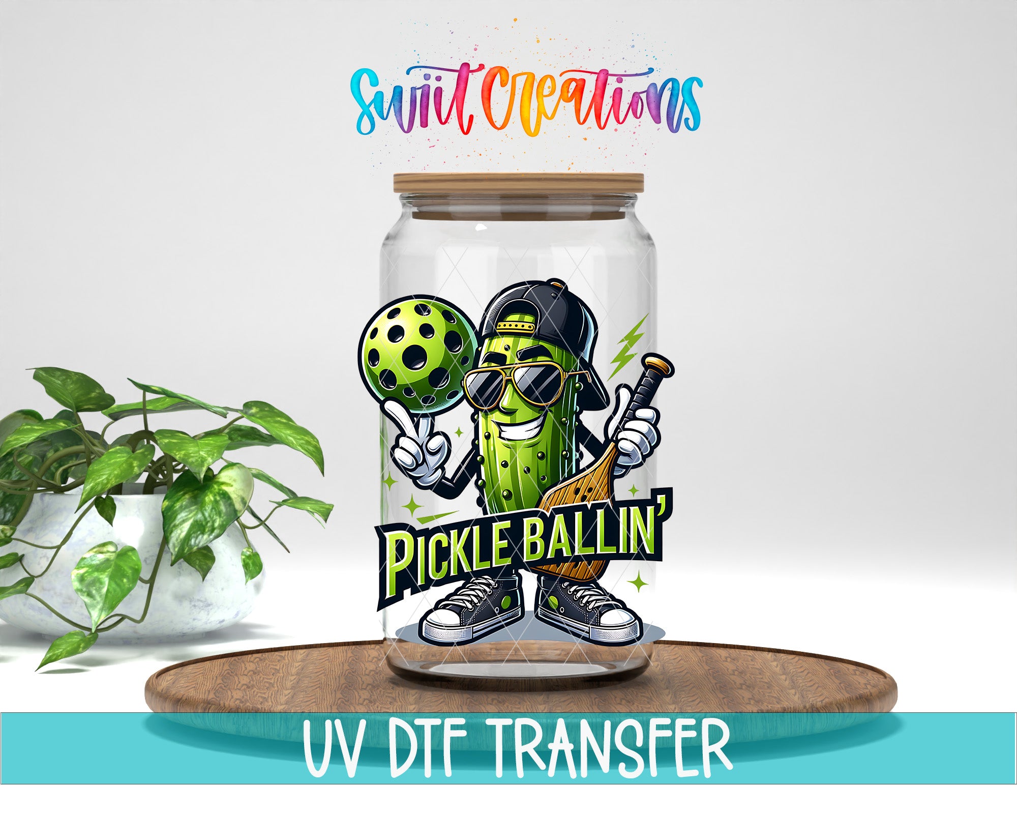 a glass jar with a cartoon pickle character and the text "Pickle Ballin'", placed on a wooden surface.