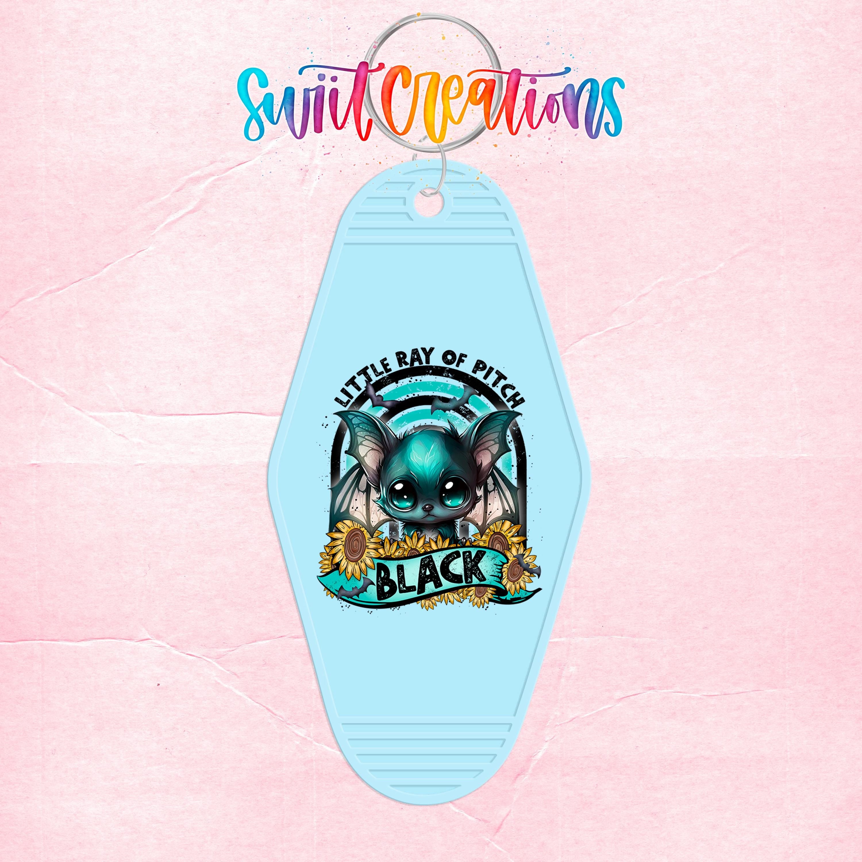 A keychain with a cartoon bat and the text "Little Bay of Pitch" and "Black" printed on it.