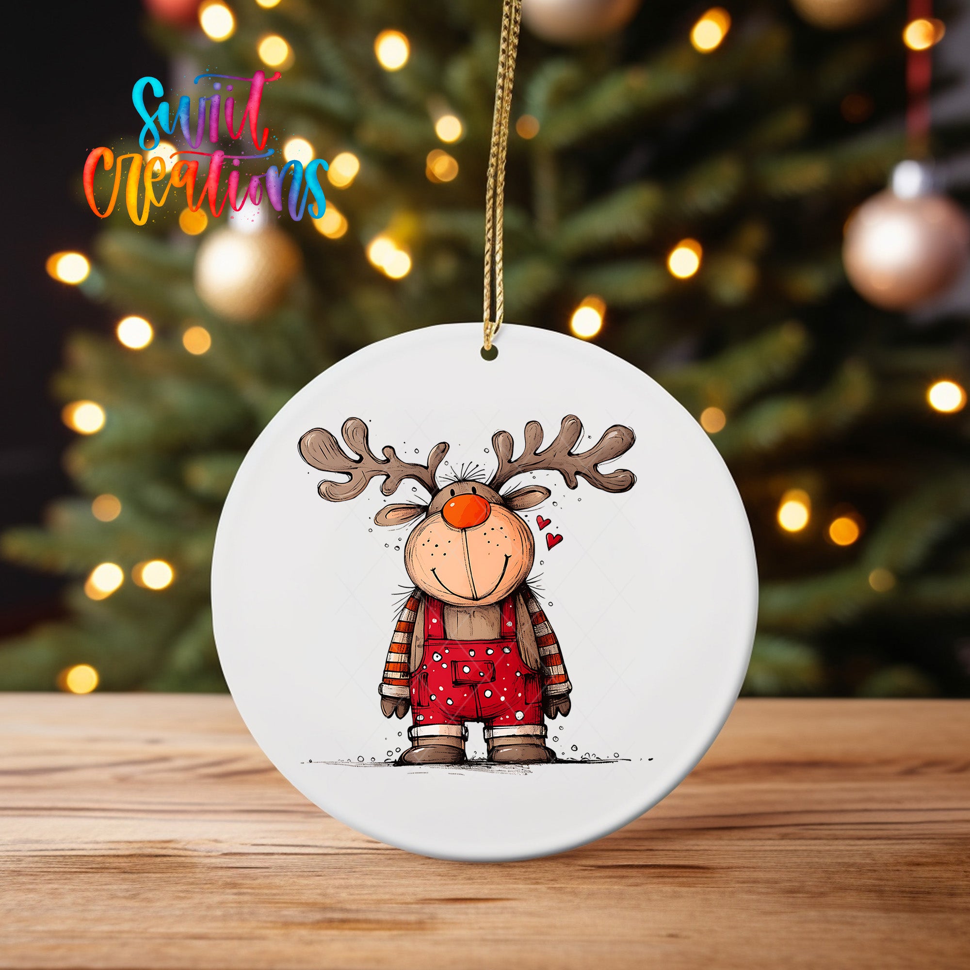 A white ornament featuring a cartoon reindeer wearing overalls and antlers, with a Christmas tree in the background.