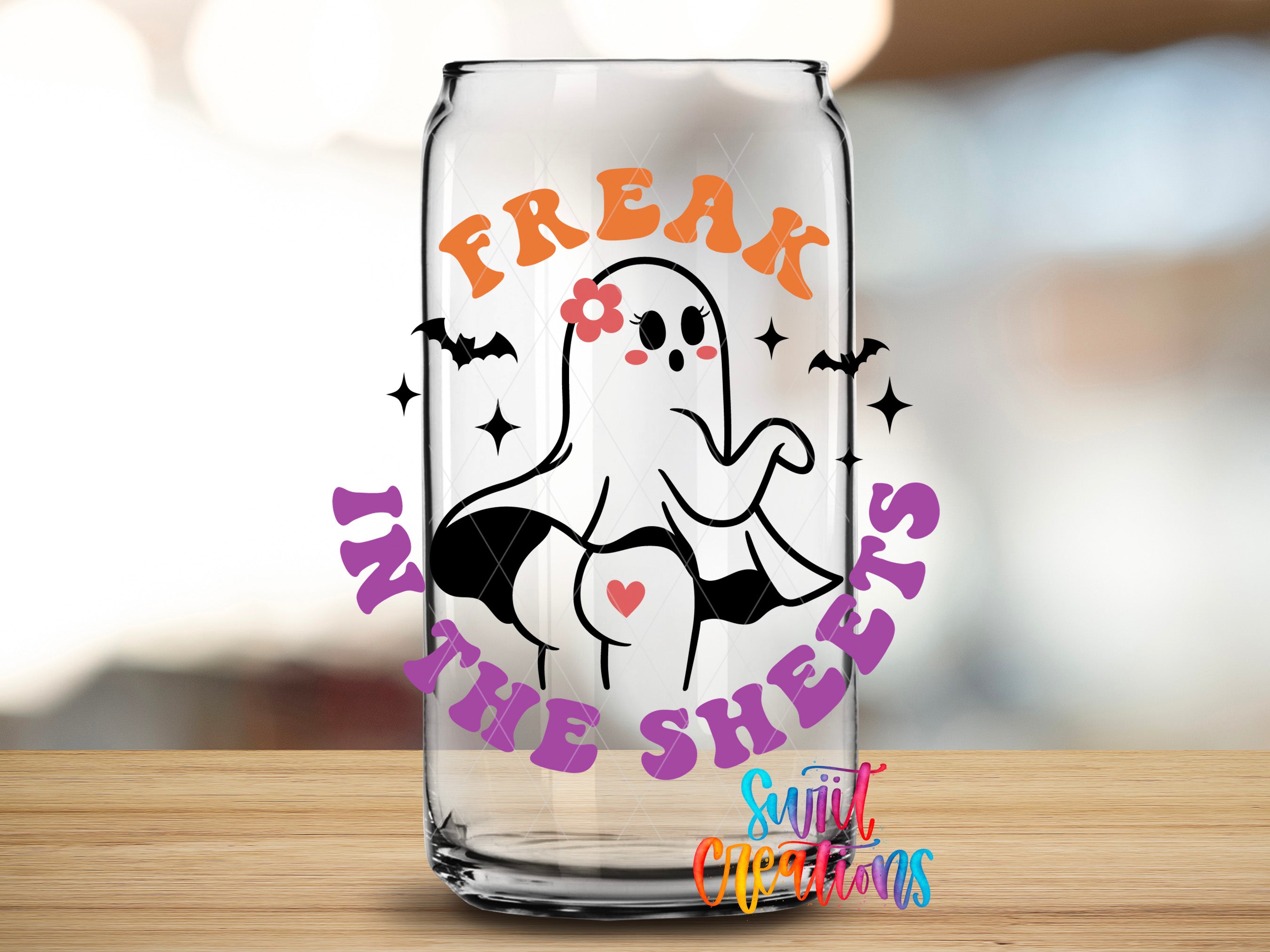 A glass can with a Halloween-themed design featuring a ghost character and the text "Freak in the Sheets" printed on it.