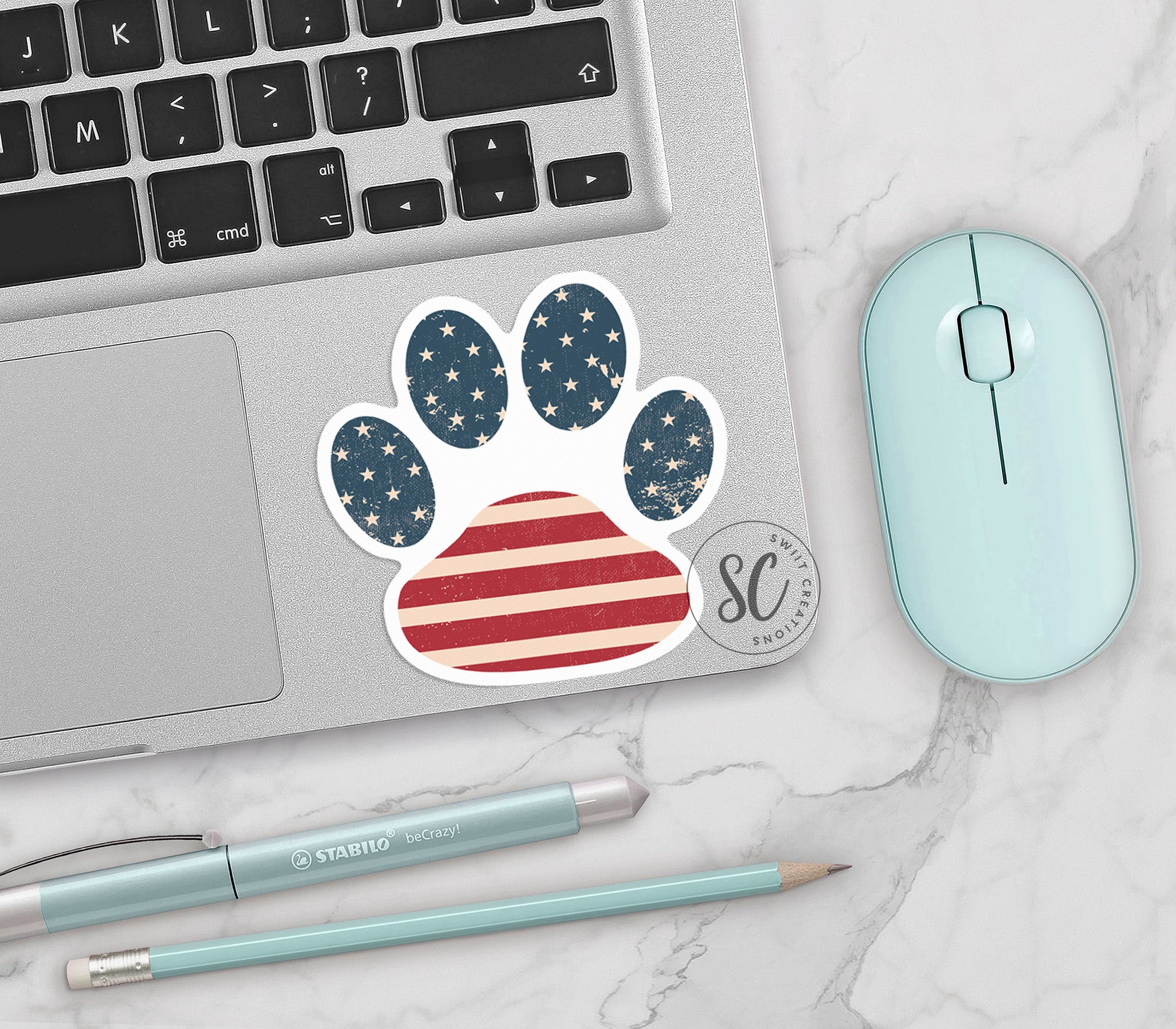 a laptop with a sticker of a dog paw on it