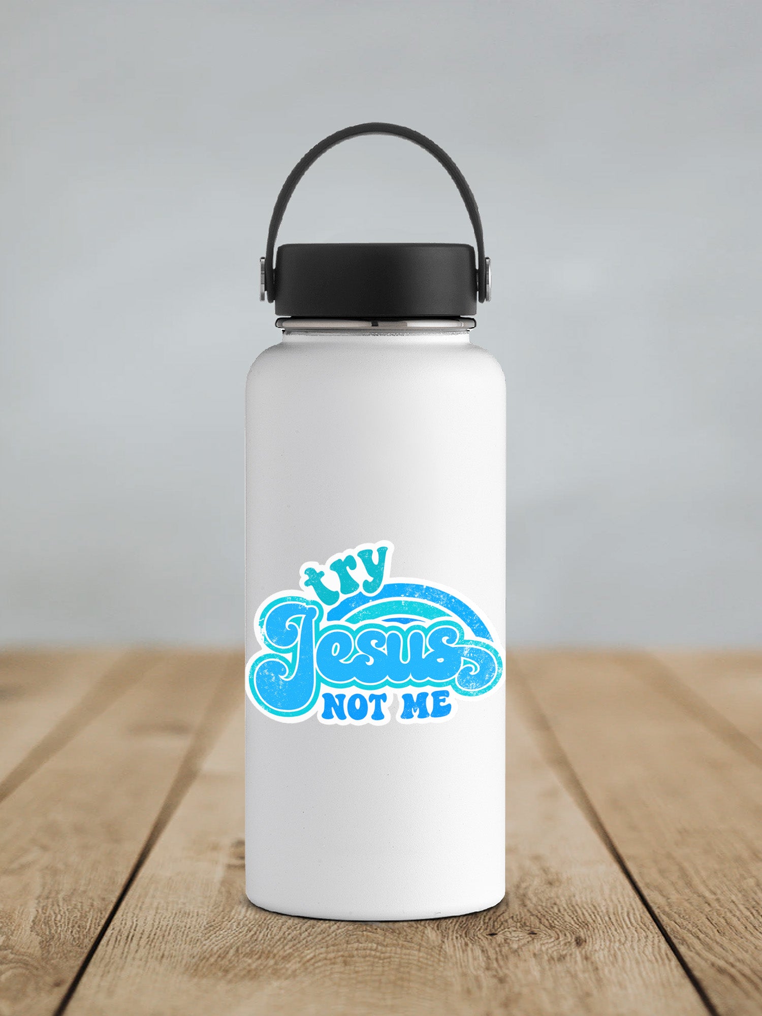a white water bottle with a black lid on a wooden table