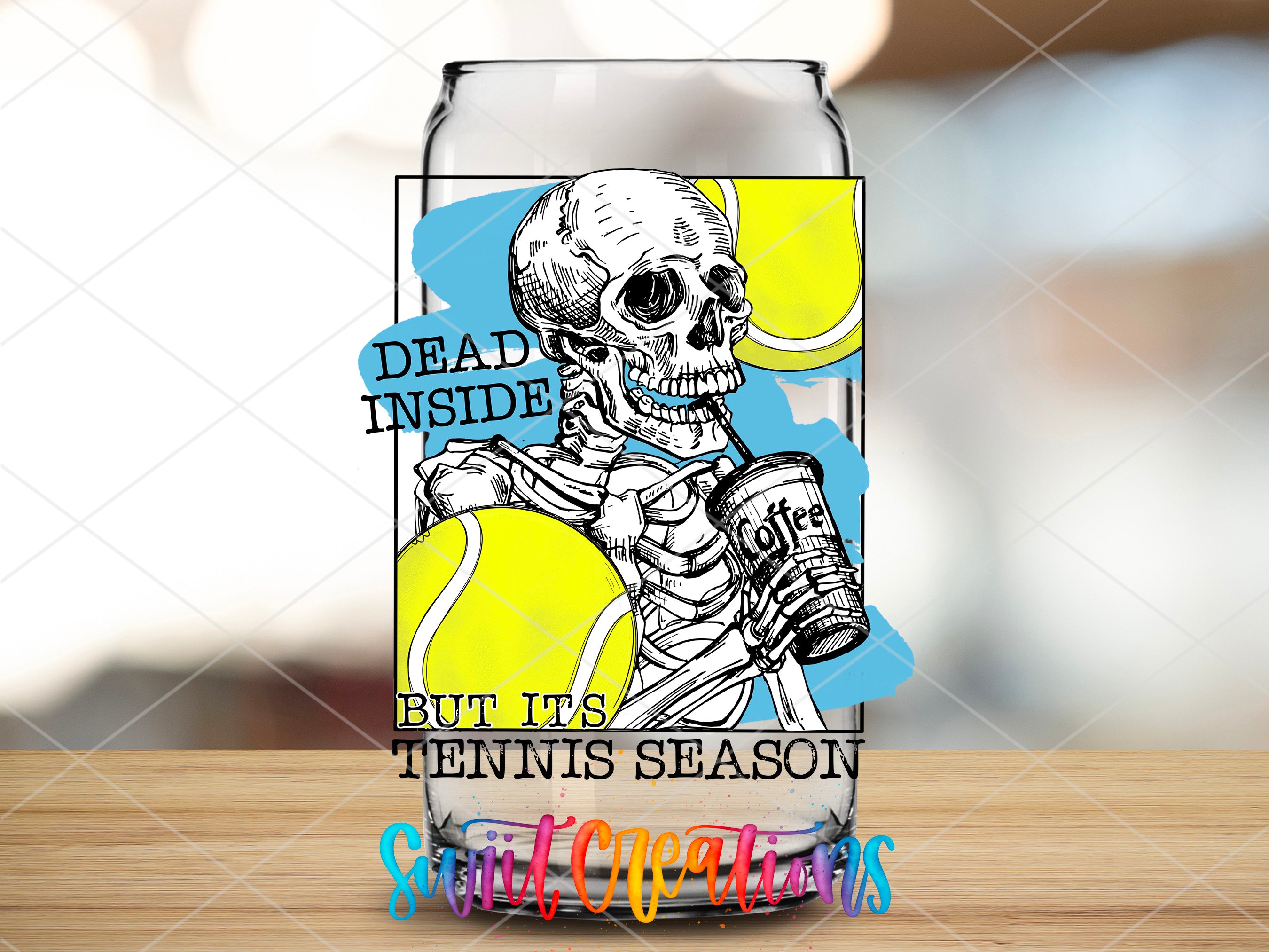 a beer glass with a skeleton holding a tennis ball