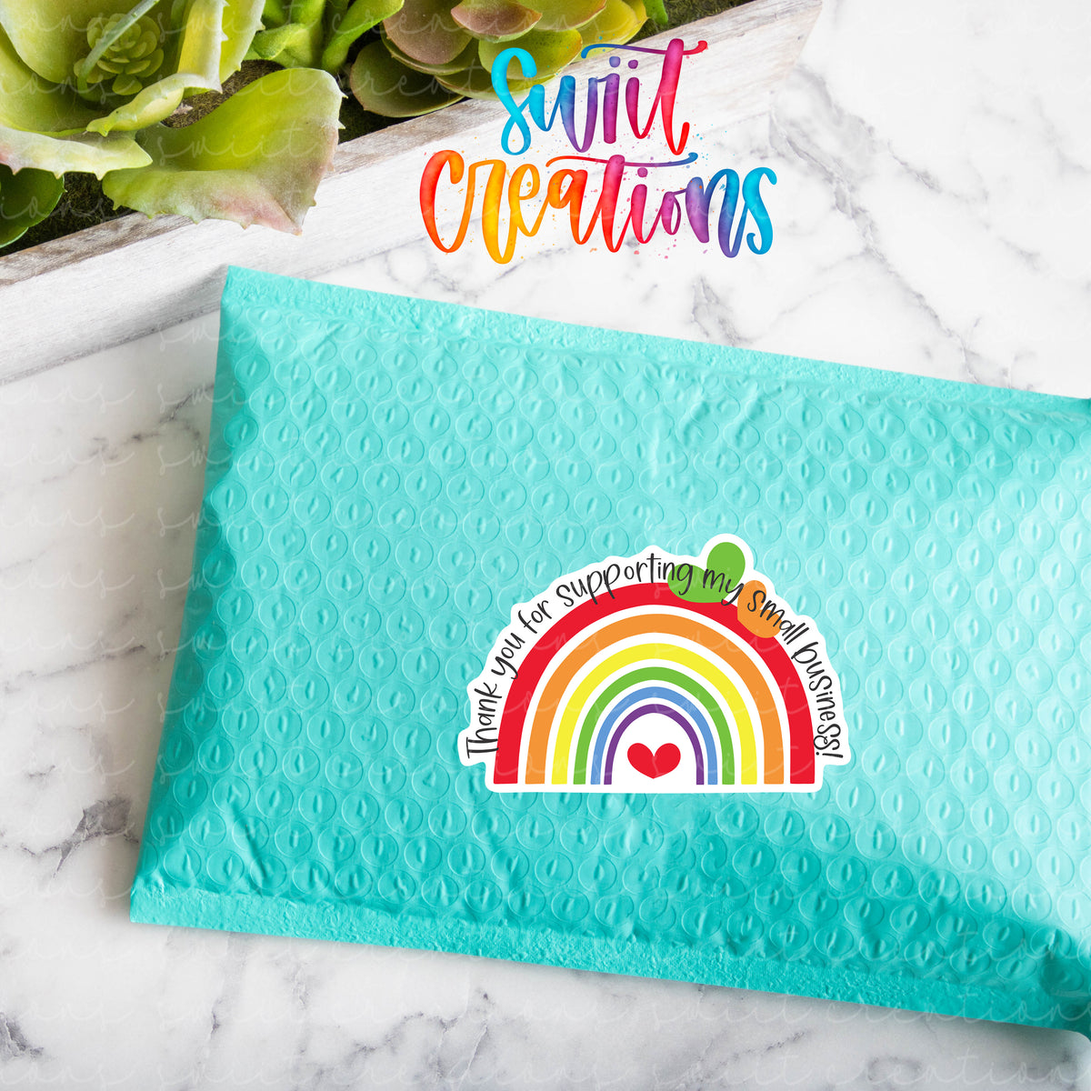 a blue envelope with a rainbow sticker on it