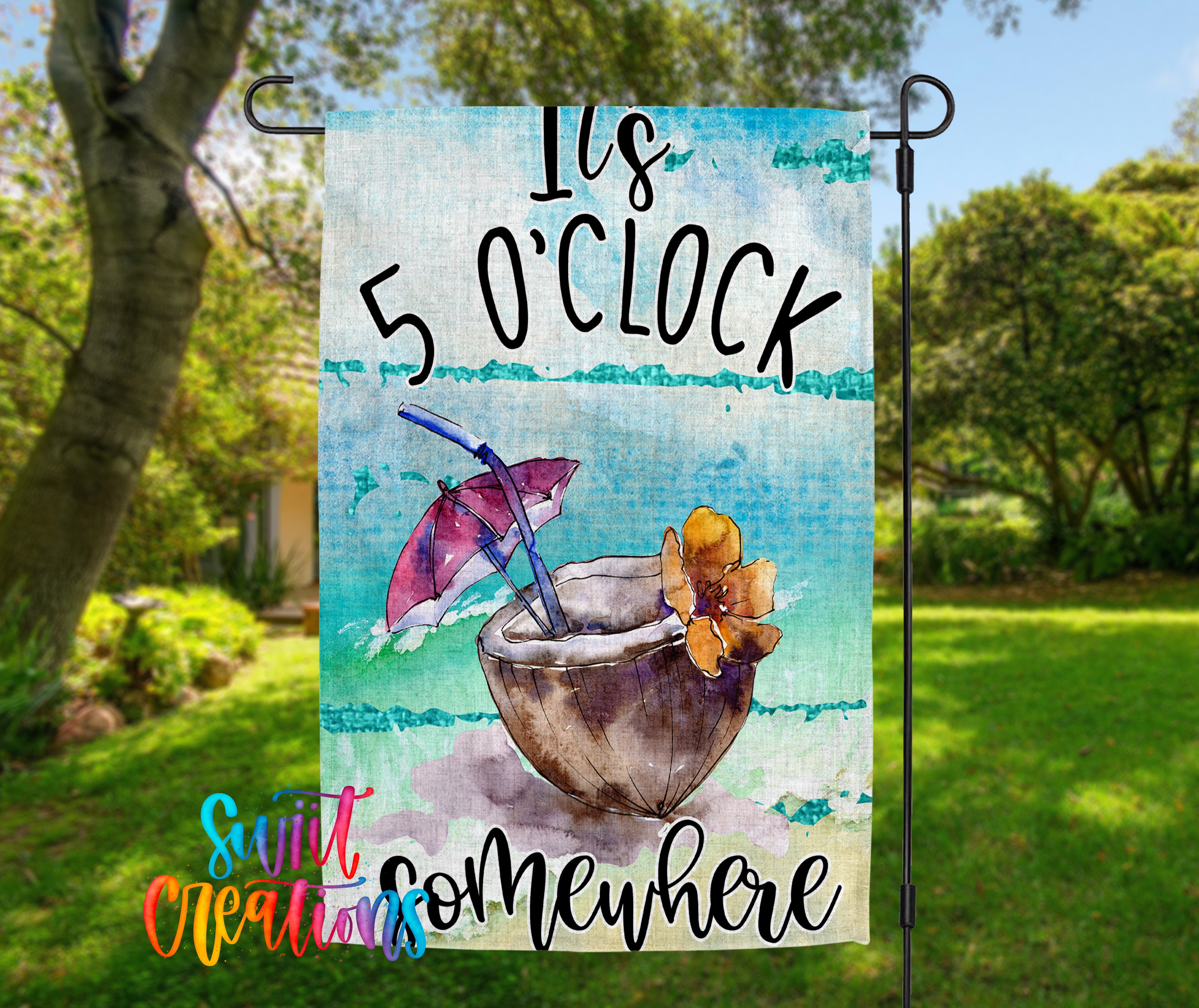 A colorful garden flag with a tropical drink and umbrella design, along with the text "It's 5 o'clock somewhere".