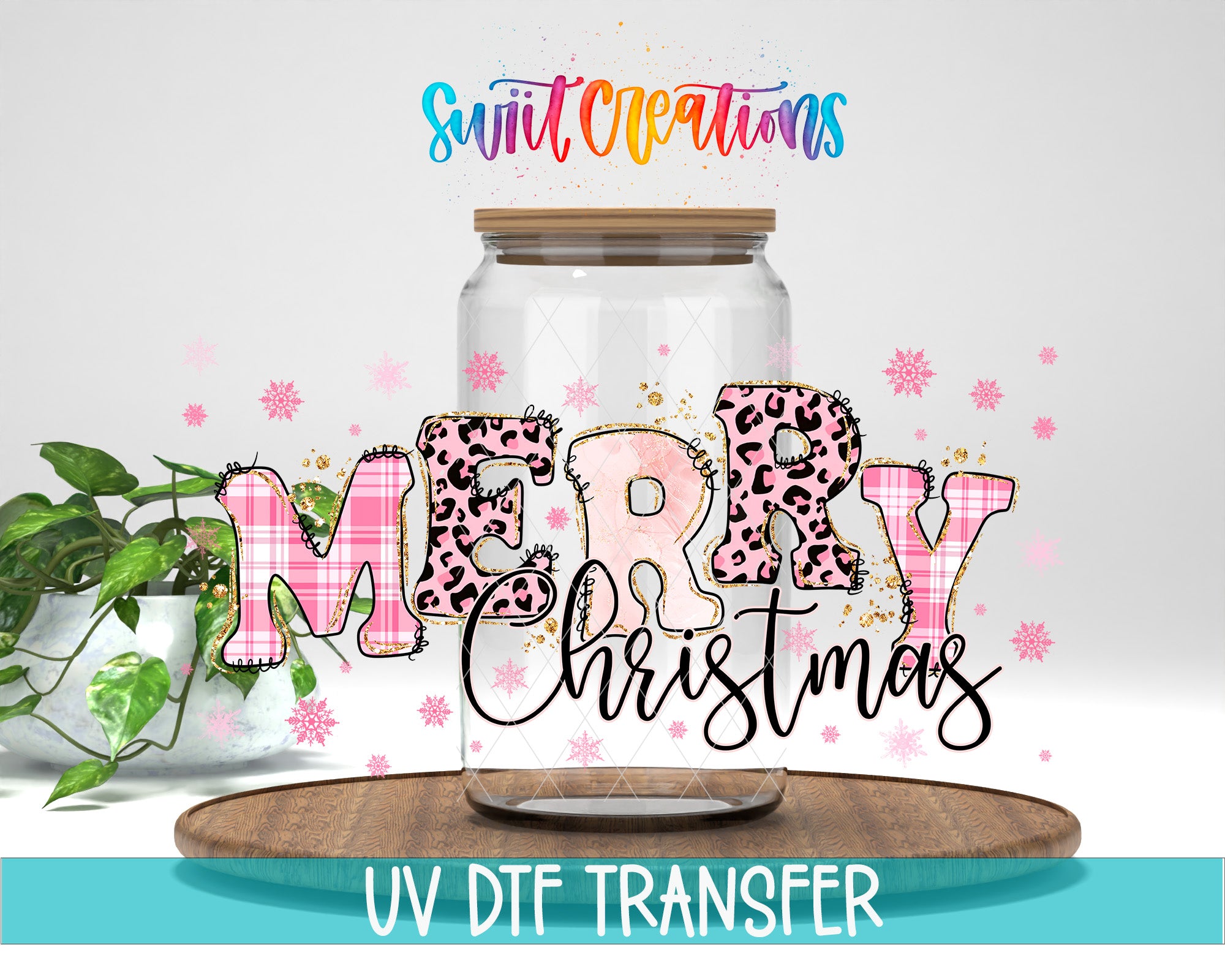 A glass jar with the word "MERRY Christmas" written on it, surrounded by pink and leopard print decorations. The jar is placed on a wooden surface, and there is a plant in the background.
