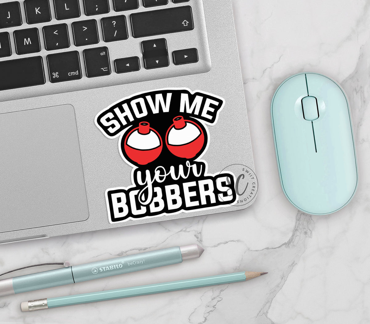 Show Me Your Bobbers vinyl sticker on a silver laptop next to a mint mouse and pens