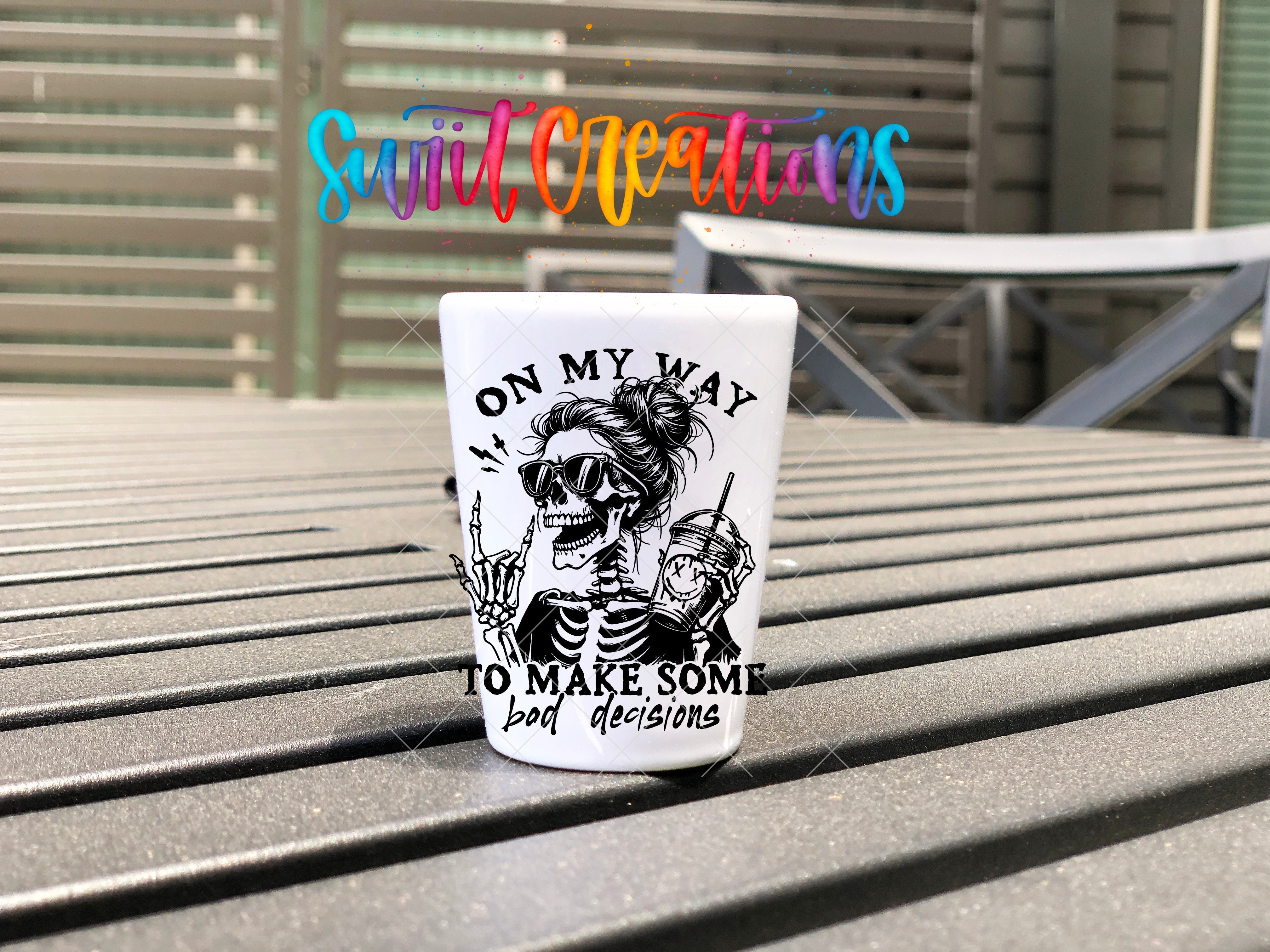 a shot glass sitting on top of a wooden table
