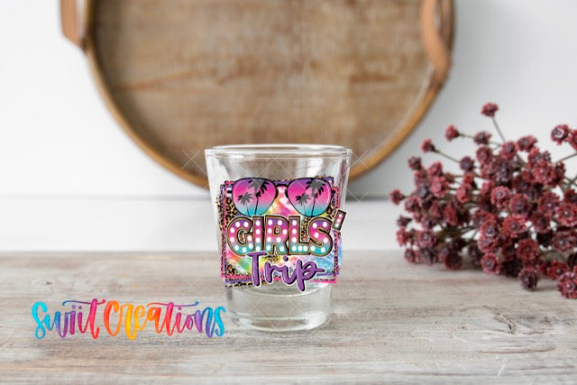 a shot glass with the word girls trip painted on it
