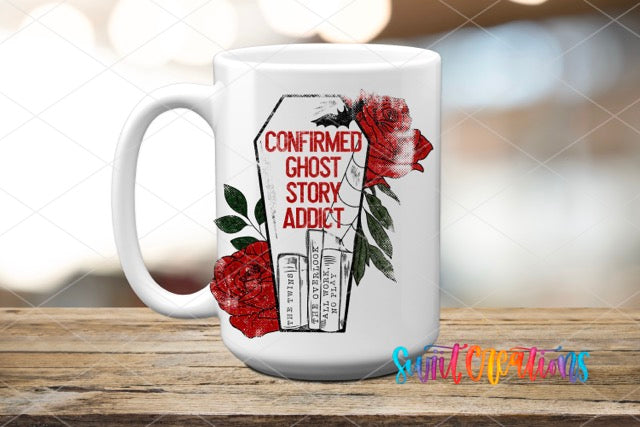 a white coffee mug with red roses on it