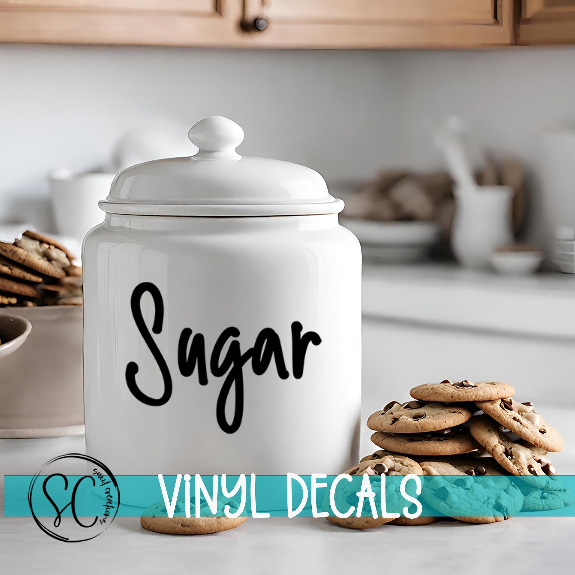 A white sugar canister with the word "Sugar" written on it, placed on a kitchen counter next to a stack of chocolate chip cookies.