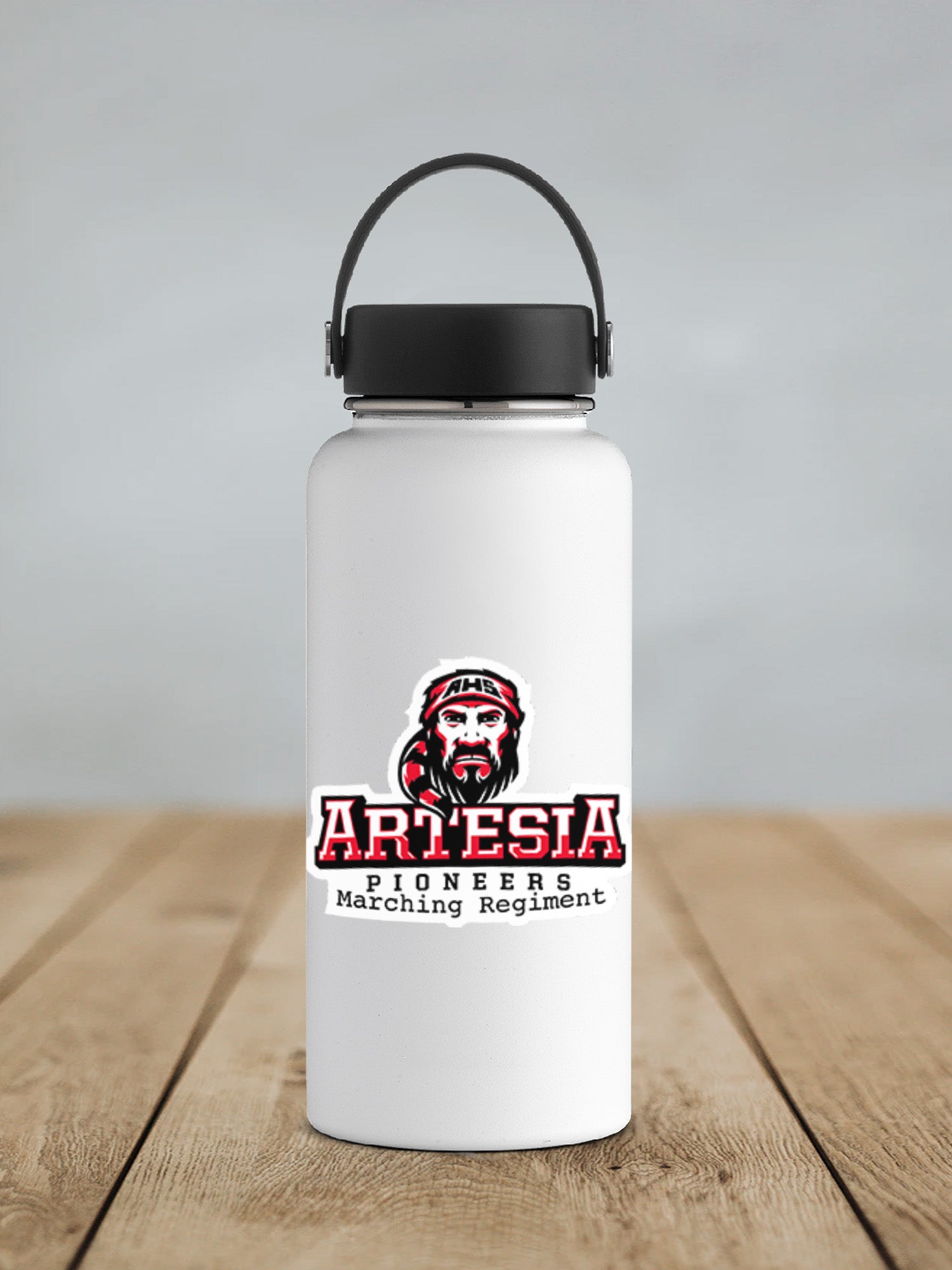 a white water bottle sitting on top of a wooden table