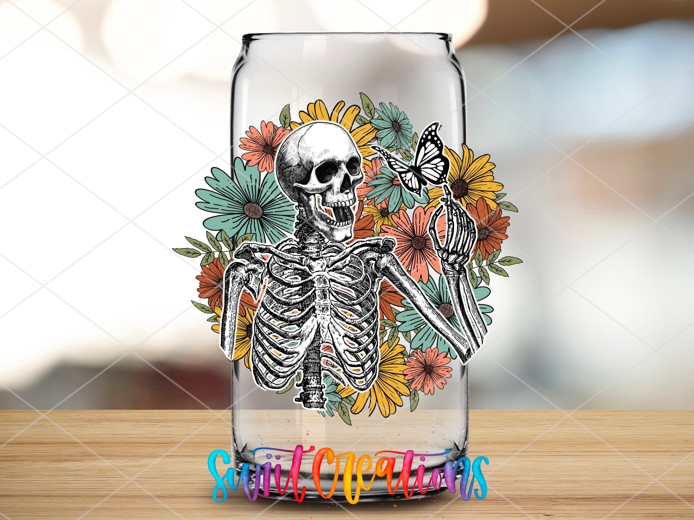 a glass with a skeleton and flowers on it