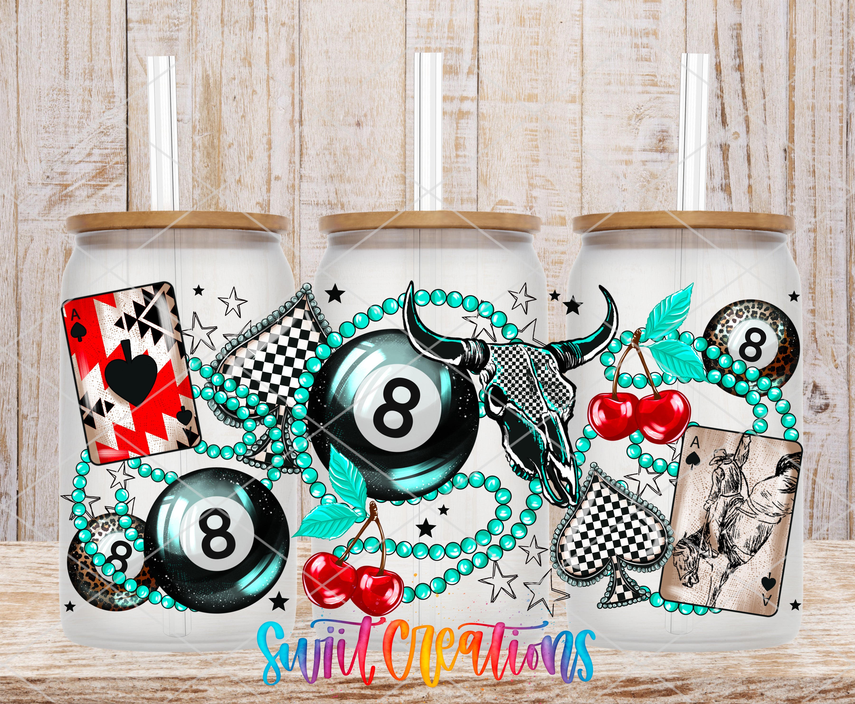 A set of three glass tumblers with various casino-themed designs and illustrations, including playing cards, billiard balls, beads, and a skull.