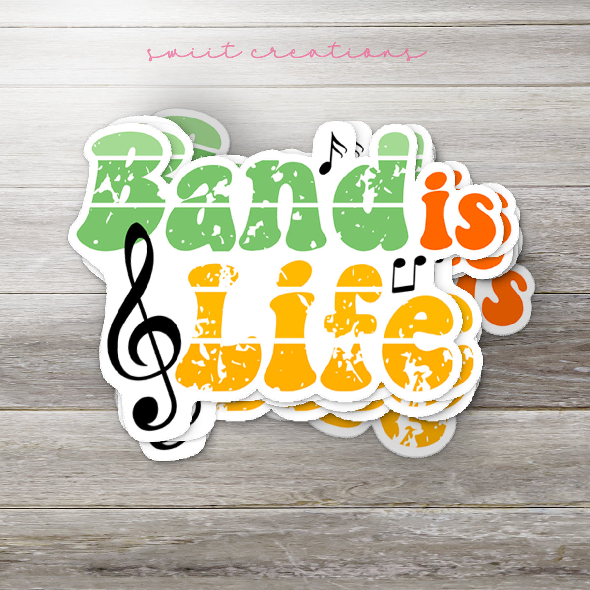 Stack of Band Is Life glossy stickers on a gray wood table