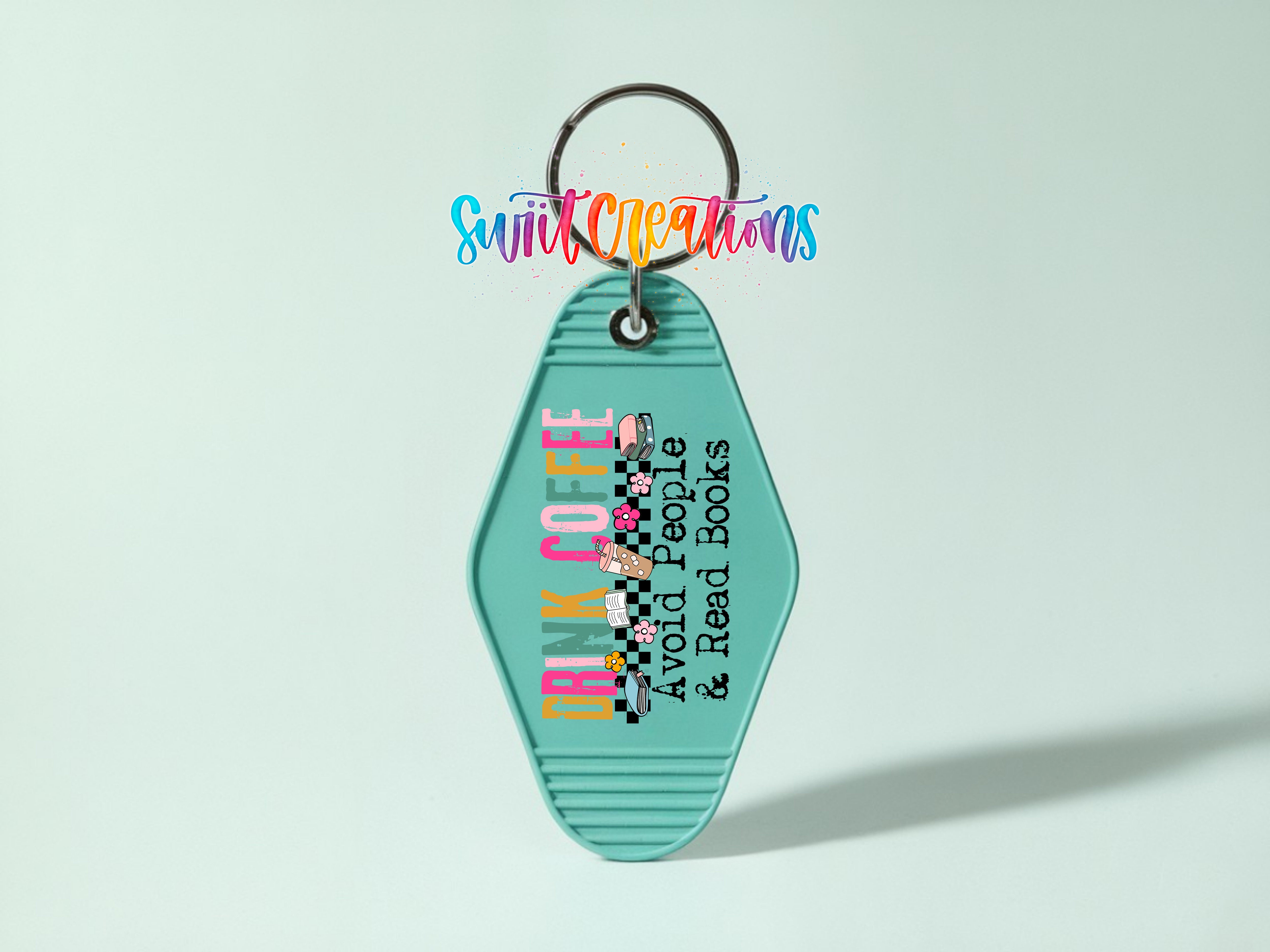A keychain with a teal color and text that says "Drink Coffee Avoid People Read Books" in a colorful, stylized font.