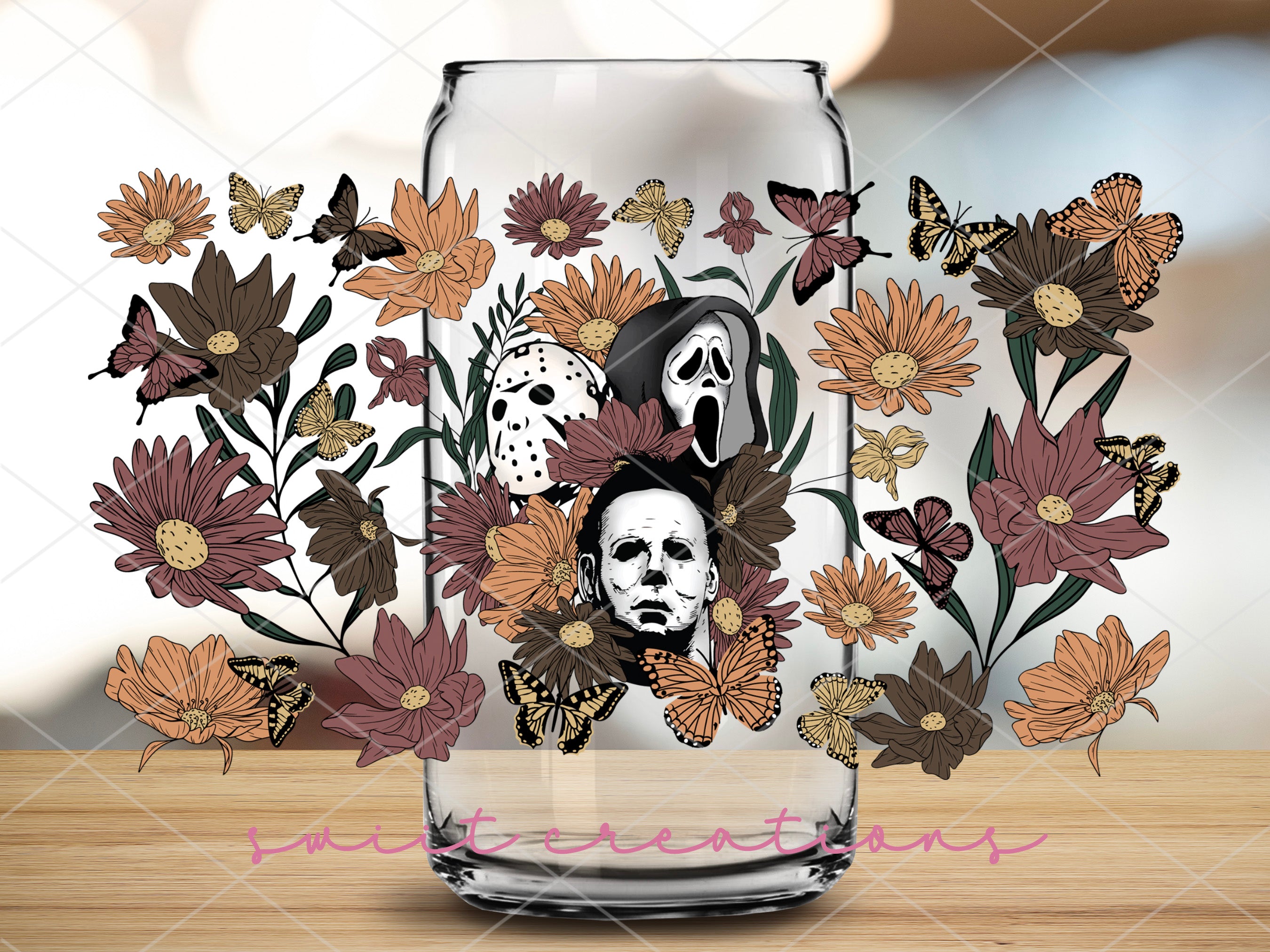 a glass with a painting of a skull and flowers
