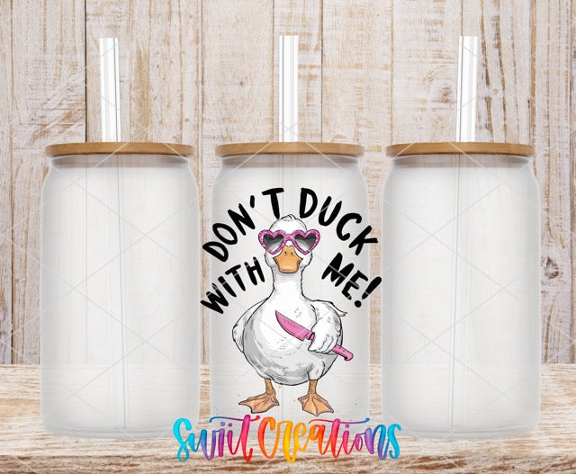 two white tumbles with a duck wearing sunglasses