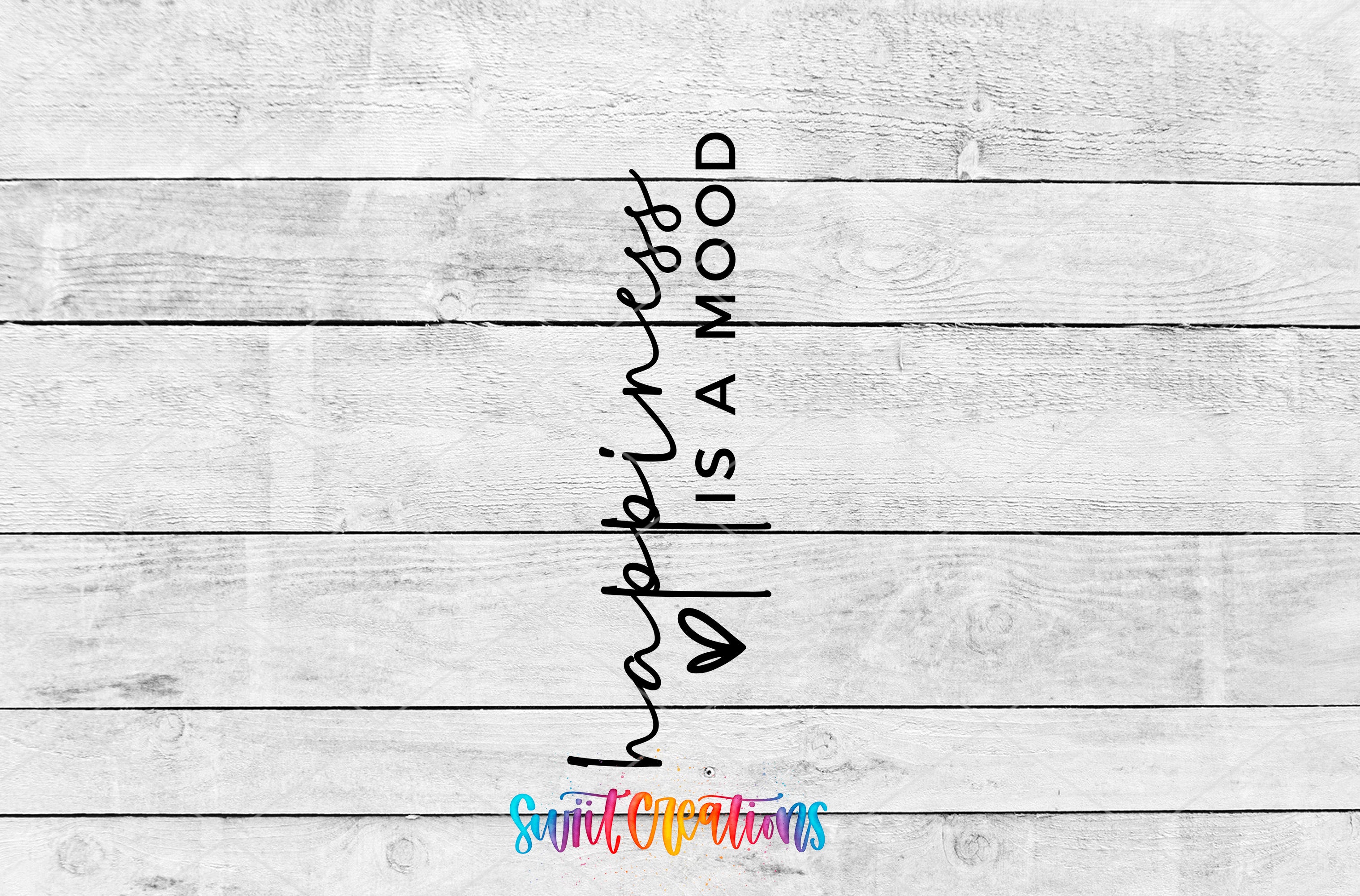 the text "happiness is a mood" written in a cursive font, which is centered on a white wooden background.
