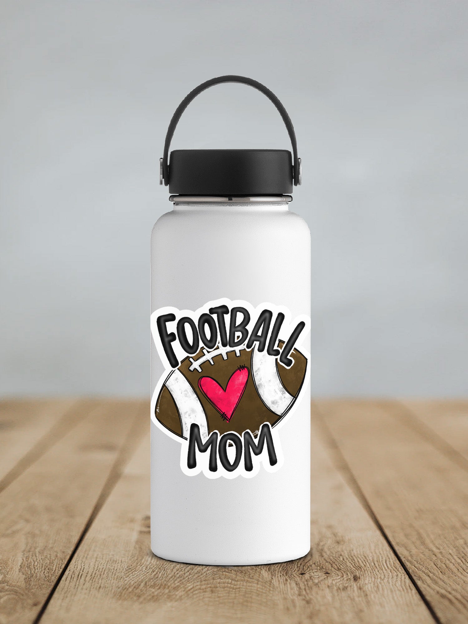 a white water bottle with a football mom sticker on it