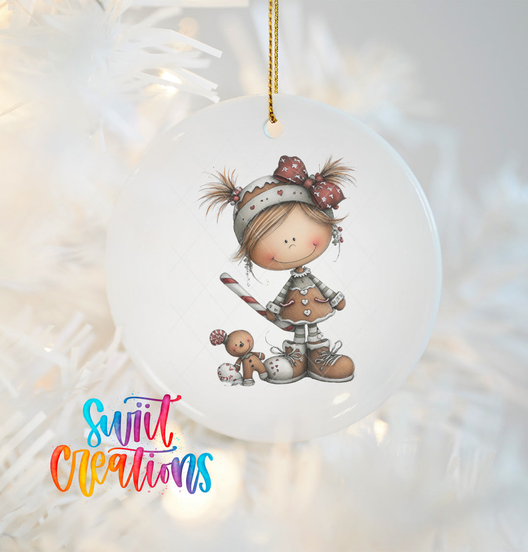 A white ornament featuring a smiling girl with a gingerbread man and a teddy bear.