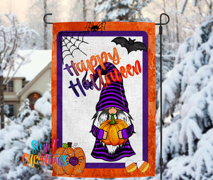 A Halloween-themed garden flag featuring a gnome holding a pumpkin and a spider web, with the text "Happy Halloween" displayed prominently.
