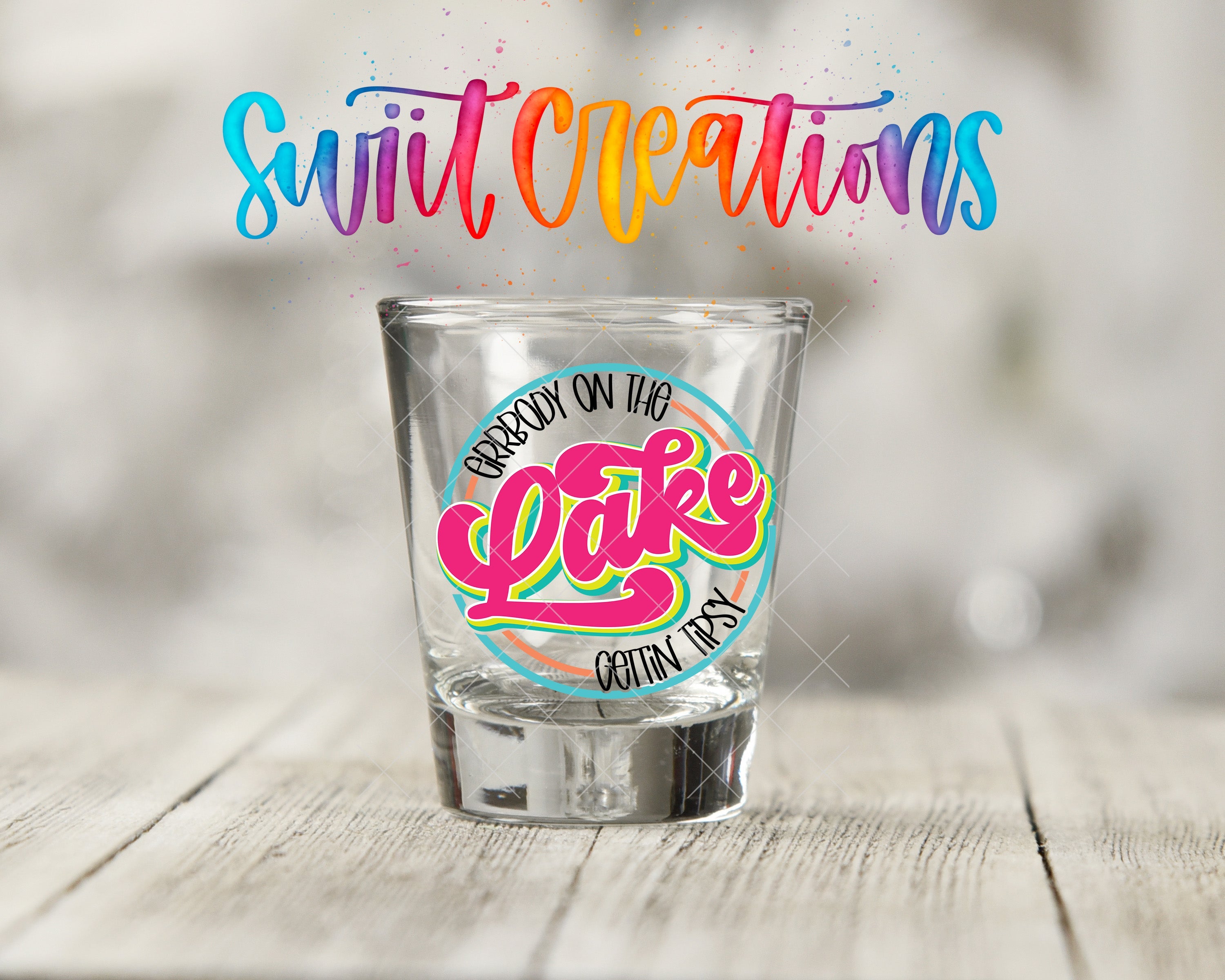 a shot glass sitting on top of a wooden table