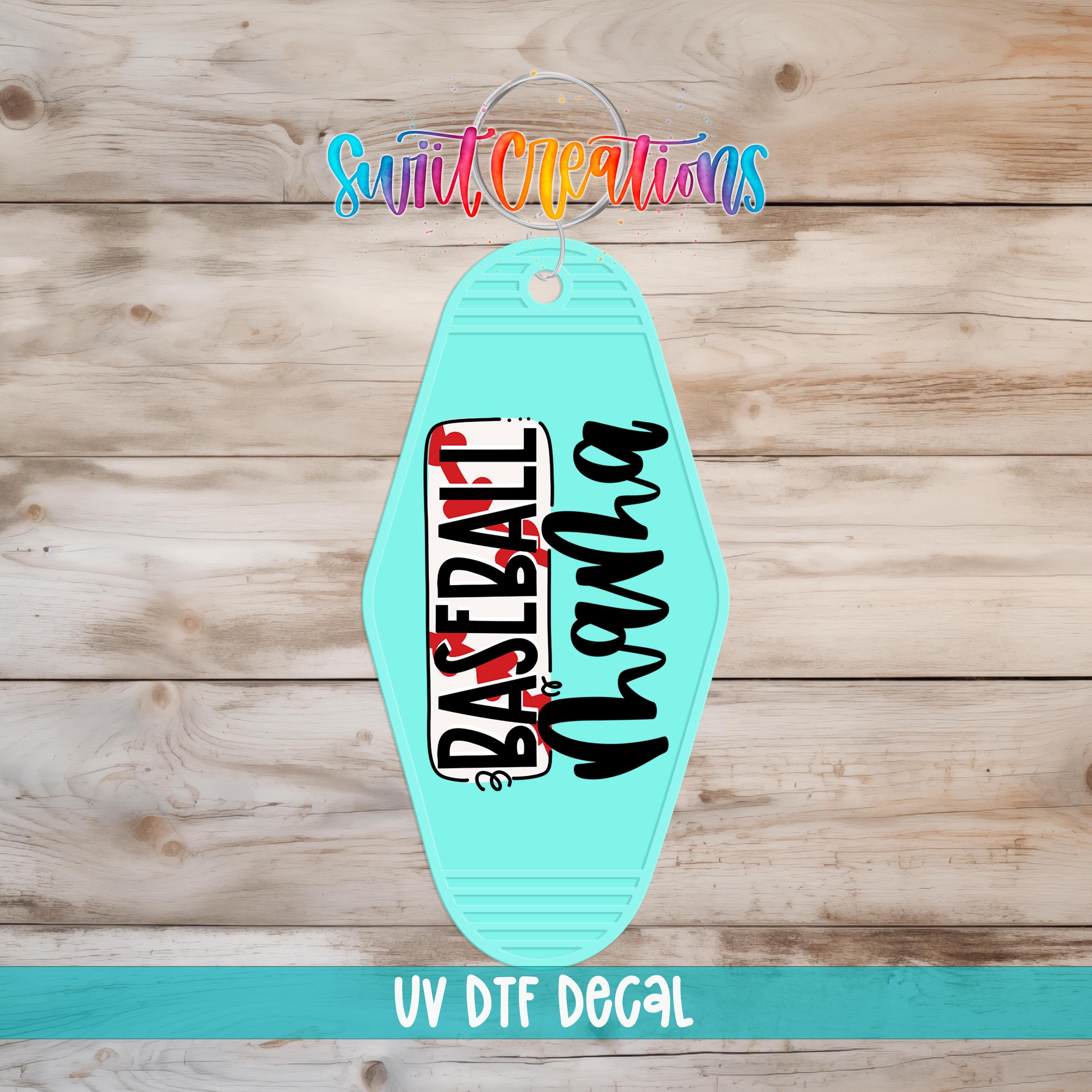 A turquoise keychain with the text "Baseball" printed on it, placed on a wooden surface.