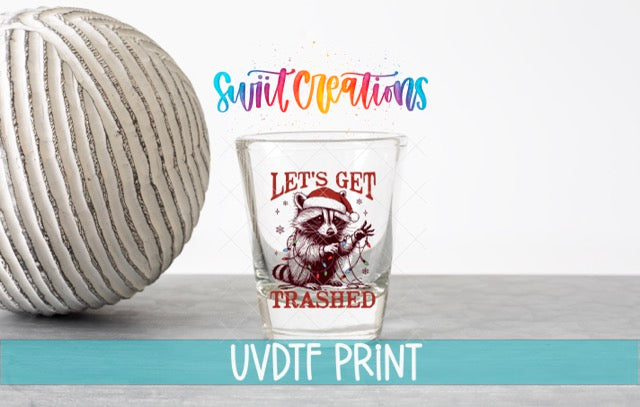 a shot glass next to a ball of yarn