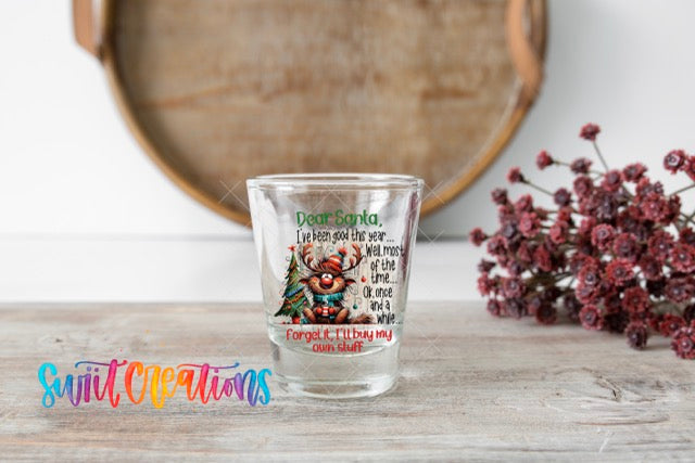 a shot glass sitting on top of a wooden table
