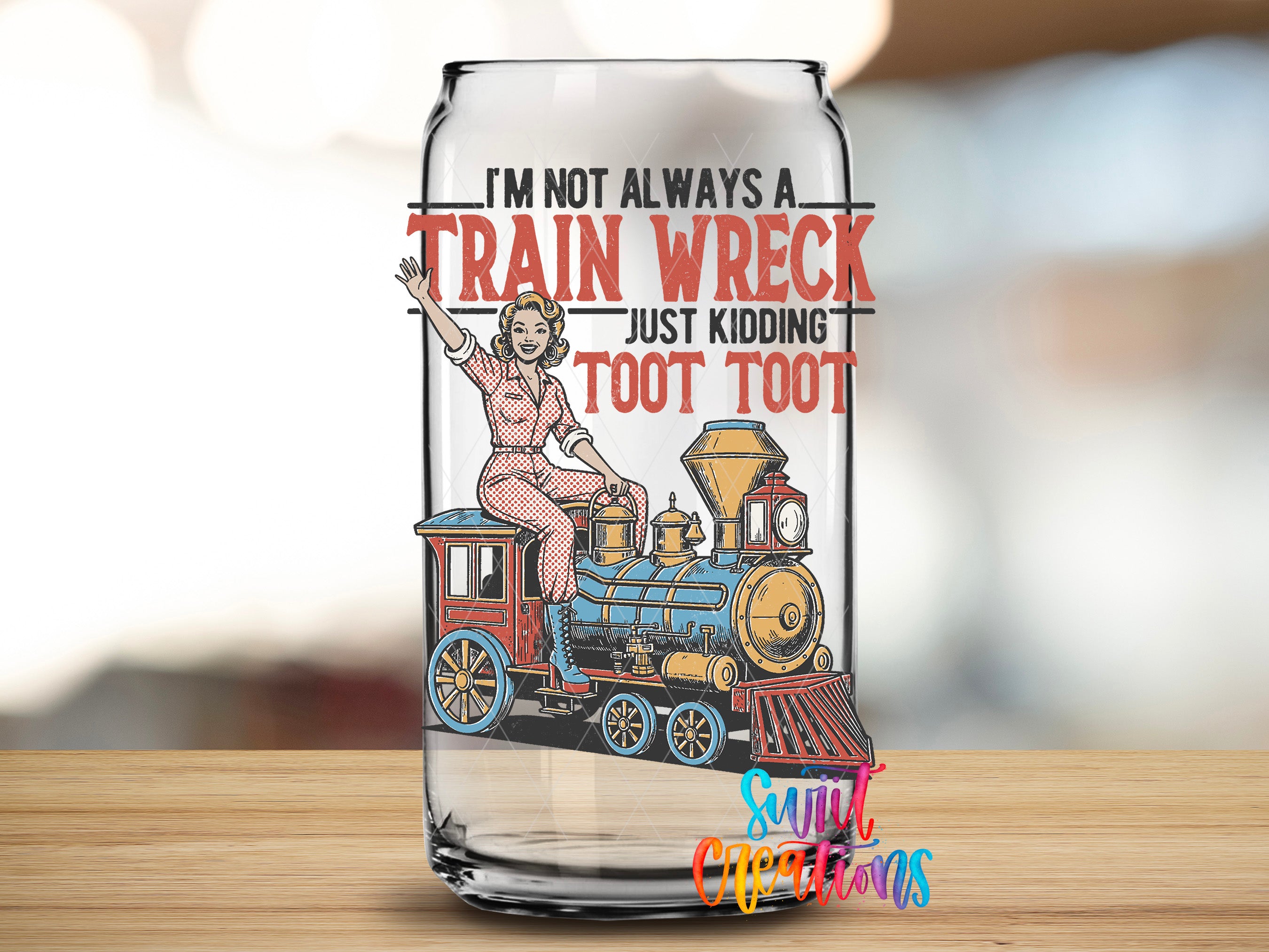 A glass can with a printed design featuring a woman riding a train and the text "I'M NOT ALWAYS A TRAIN WRECK JUST KIDDING Toot Toot" printed on it.